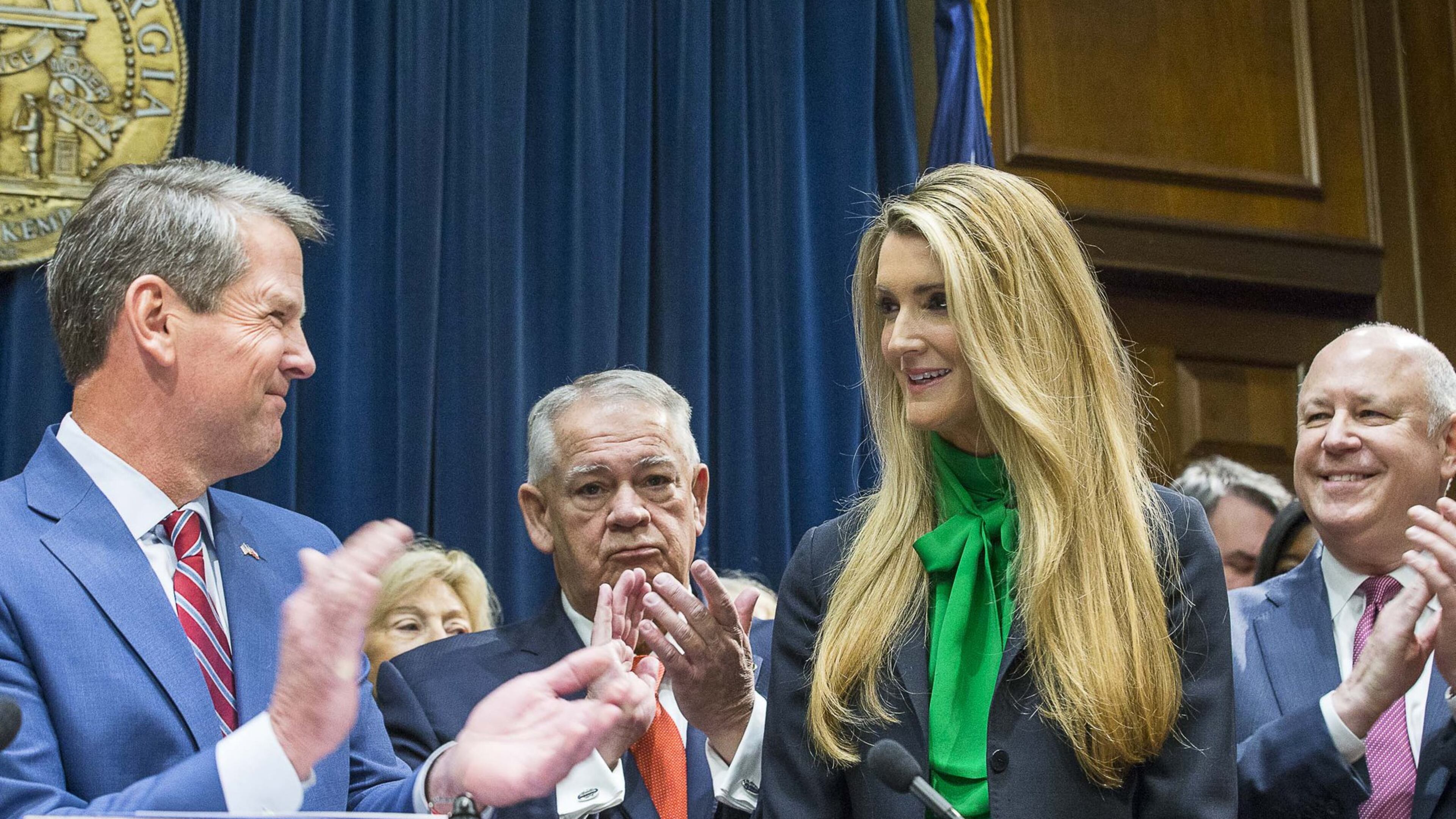 Lawmakers applaud as newly appointed U.S. Sen. Kelly Loeffler (second from right) is introduced by Georgia Gov. Brian Kemp (left) during a press conference Wednesday, Dec, 4, 2019. Georgia Gov. Brian Kemp appointed Loeffler to the U.S. Senate to take the place of Johnny Isakson, who is stepping down for health reasons. (ALYSSA POINTER/ALYSSA.POINTER@AJC.COM)