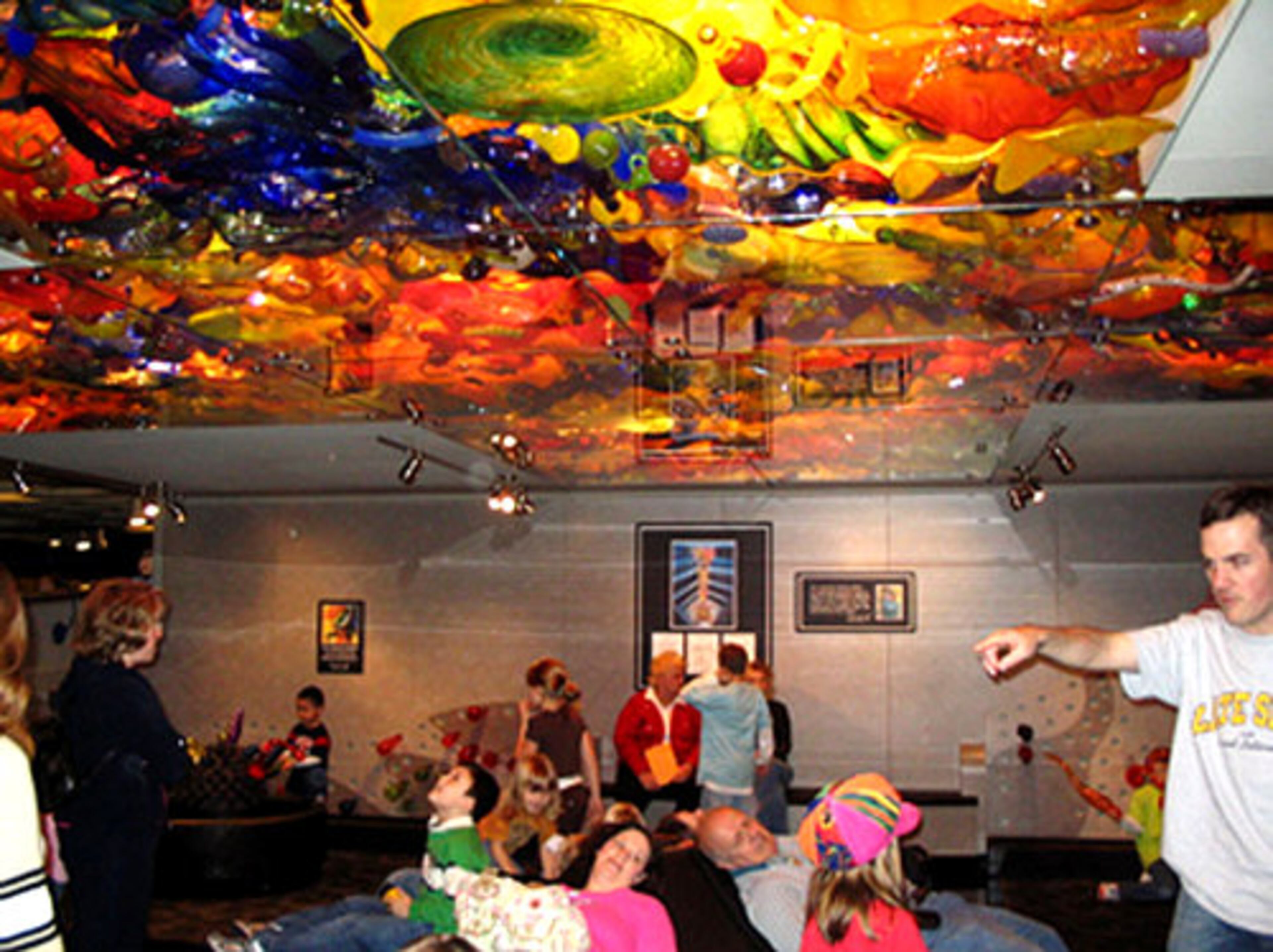 At the Children's Museum of Indianapolis, families can admire a 43-foot-tall blown glass sculpture by Dale Chihuly, then lie on a turning platform and view the work through a glass ceiling.