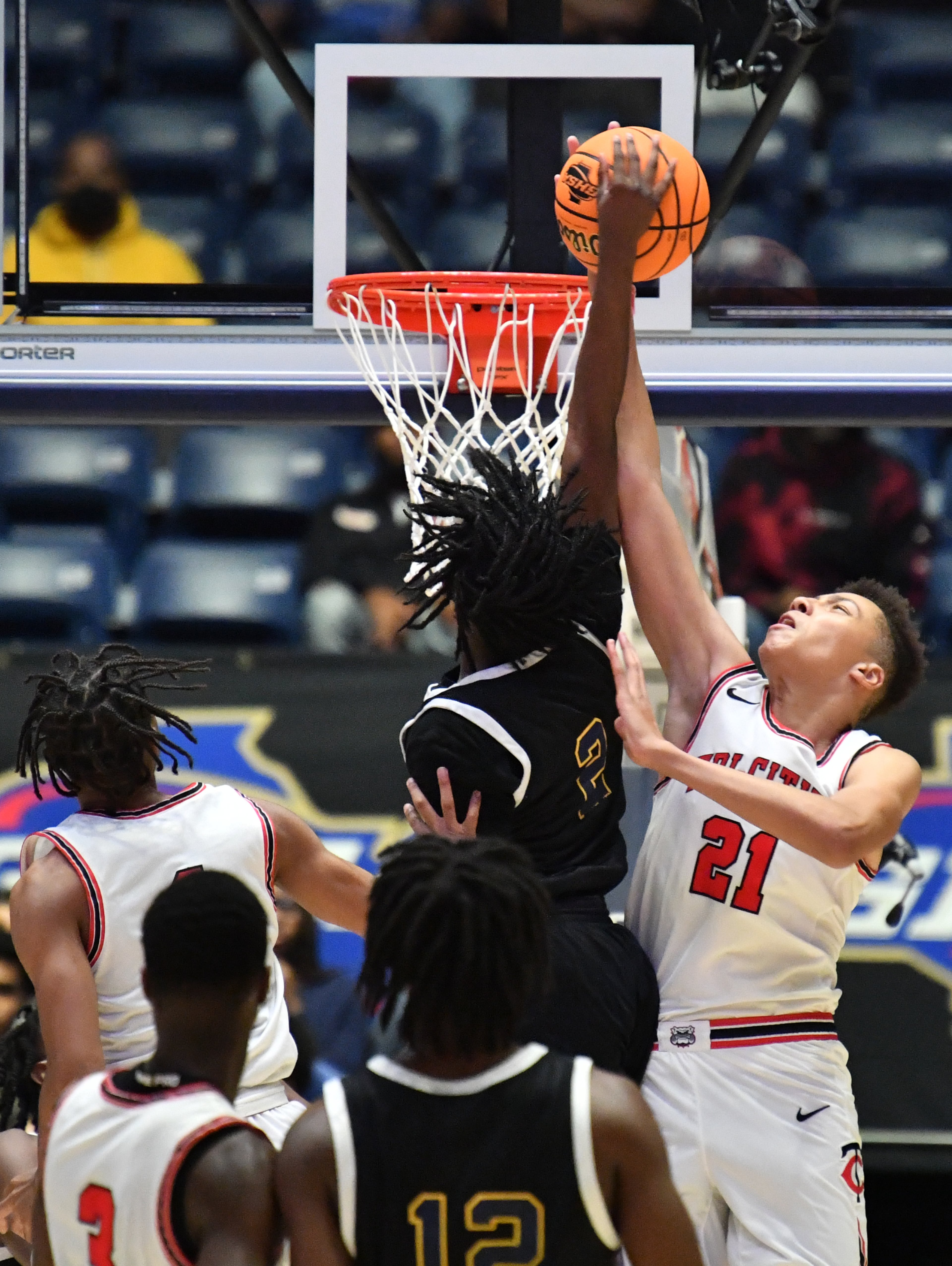 Tri-Cities' Ryan Mathieu (21) blocks the shot by Eagle's Landing's Nick Mason (2) during the 2022 GHSA State Basketball Class AAAAA Boys Championship game at the Macon Centreplex in Macon on Thursday, March 10, 2022. Tri-Cities won 67-59 over Eagle's Landing. (Hyosub Shin / Hyosub.Shin@ajc.com)