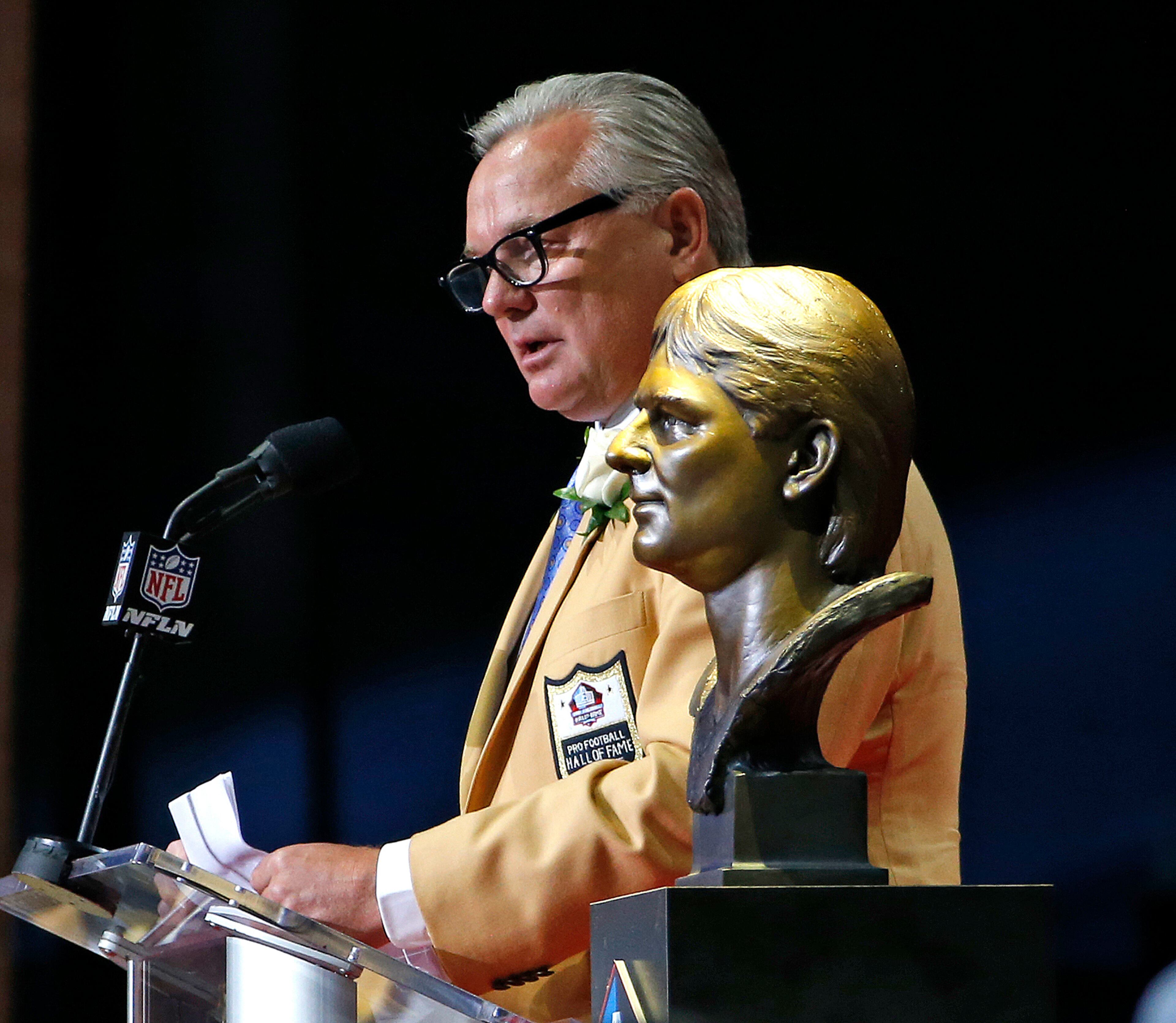 Morten Andersen speaks next to his bust during inductions at the Pro Football Hall of Fame on Saturday, Aug. 5, 2017, in Canton, Ohio. (AP Photo/Ron Schwane)