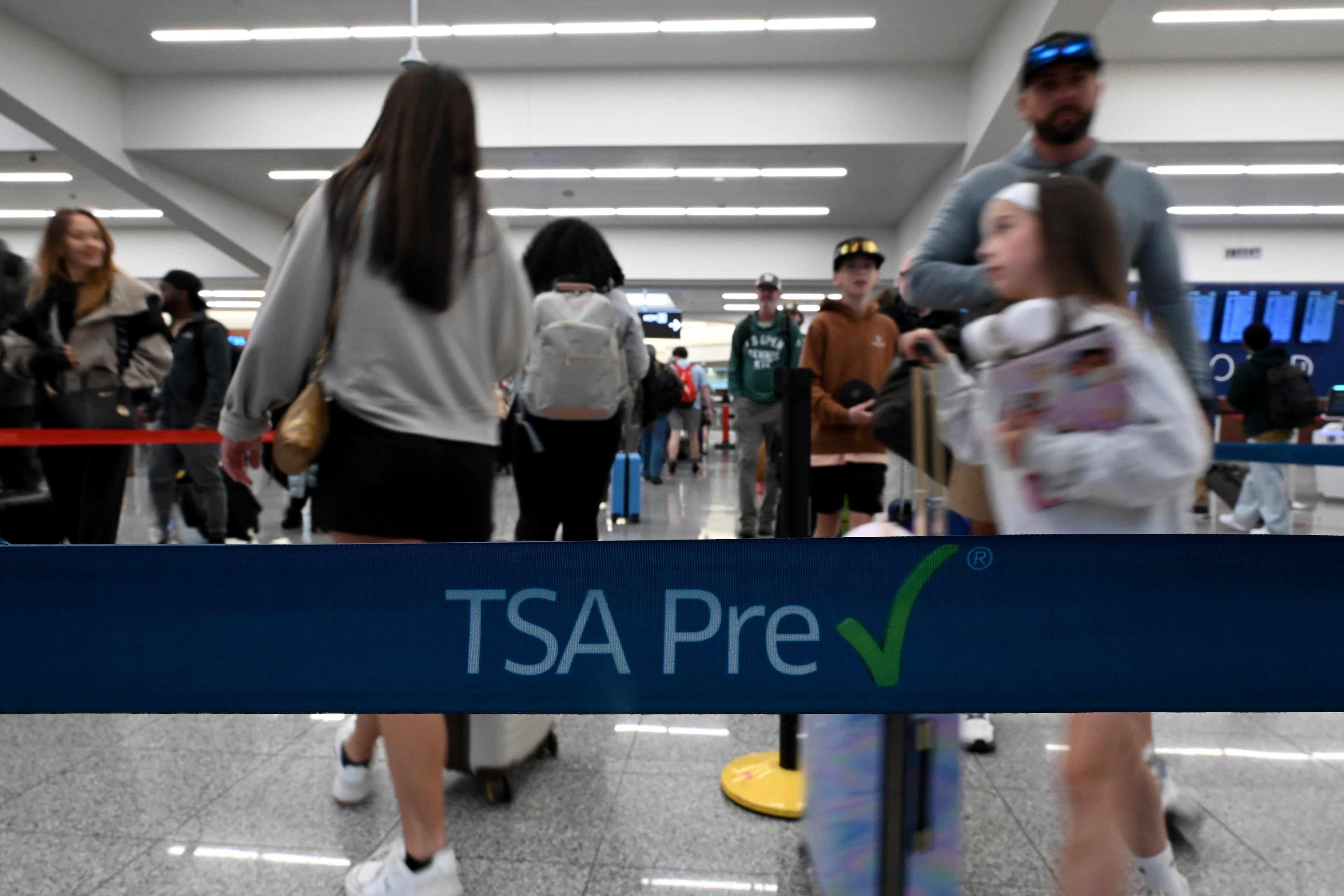 Early morning travelers wait in long lines extending to the baggage claim area as they wait to get through security screening amid the partial government shutdown at Hartsfield-Jackson Atlanta International Airport on Saturday, March 21, 2026, in Atlanta. (Hyosub Shin/AJC)