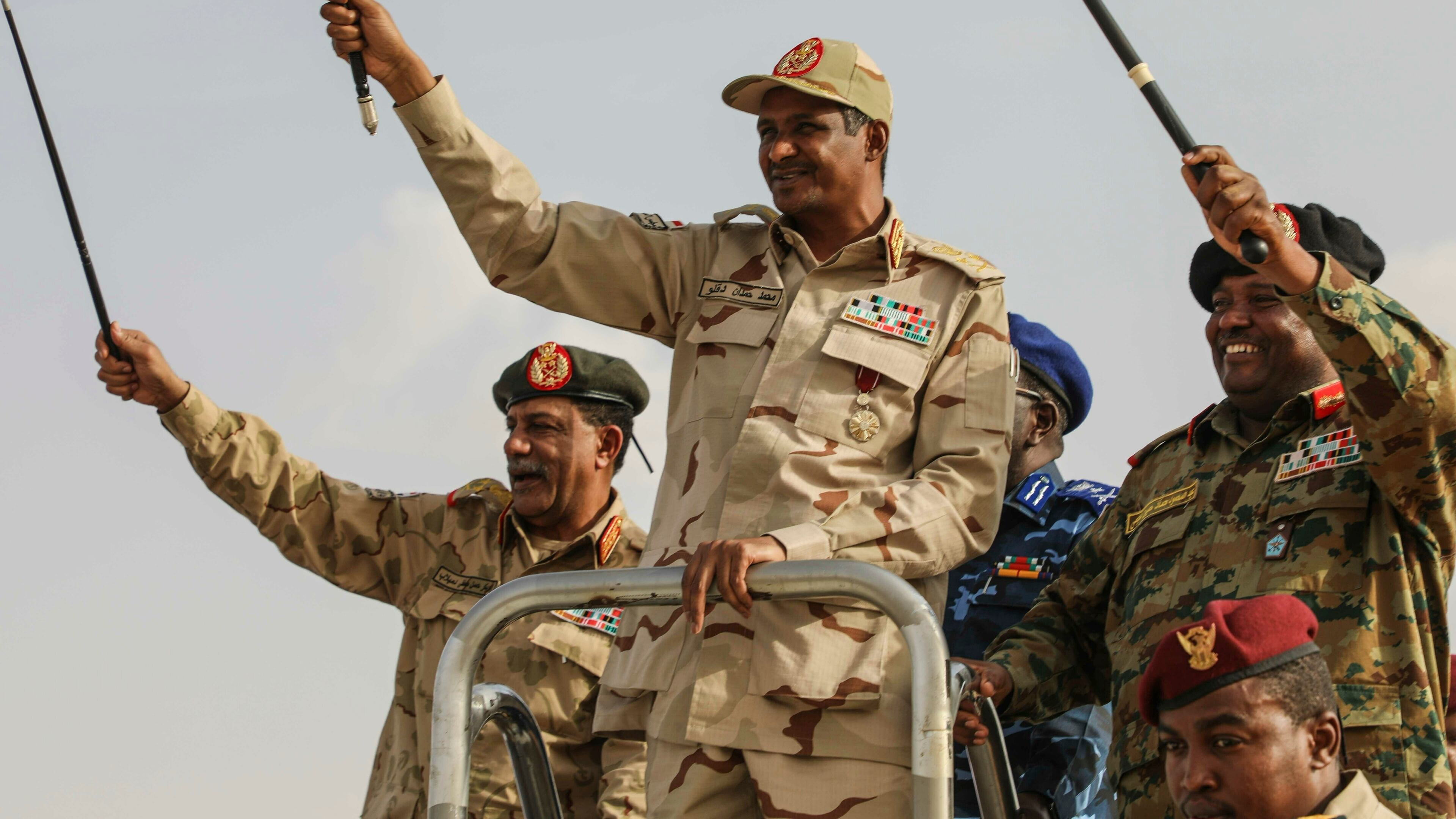 FILE - Gen. Mohammed Hamdan Dagalo, center, greets the crowd during a military-backed tribes' rally in the Nile River State of Sudan, July 13, 2019. (AP Photo/Mahmoud Hjaj, File)