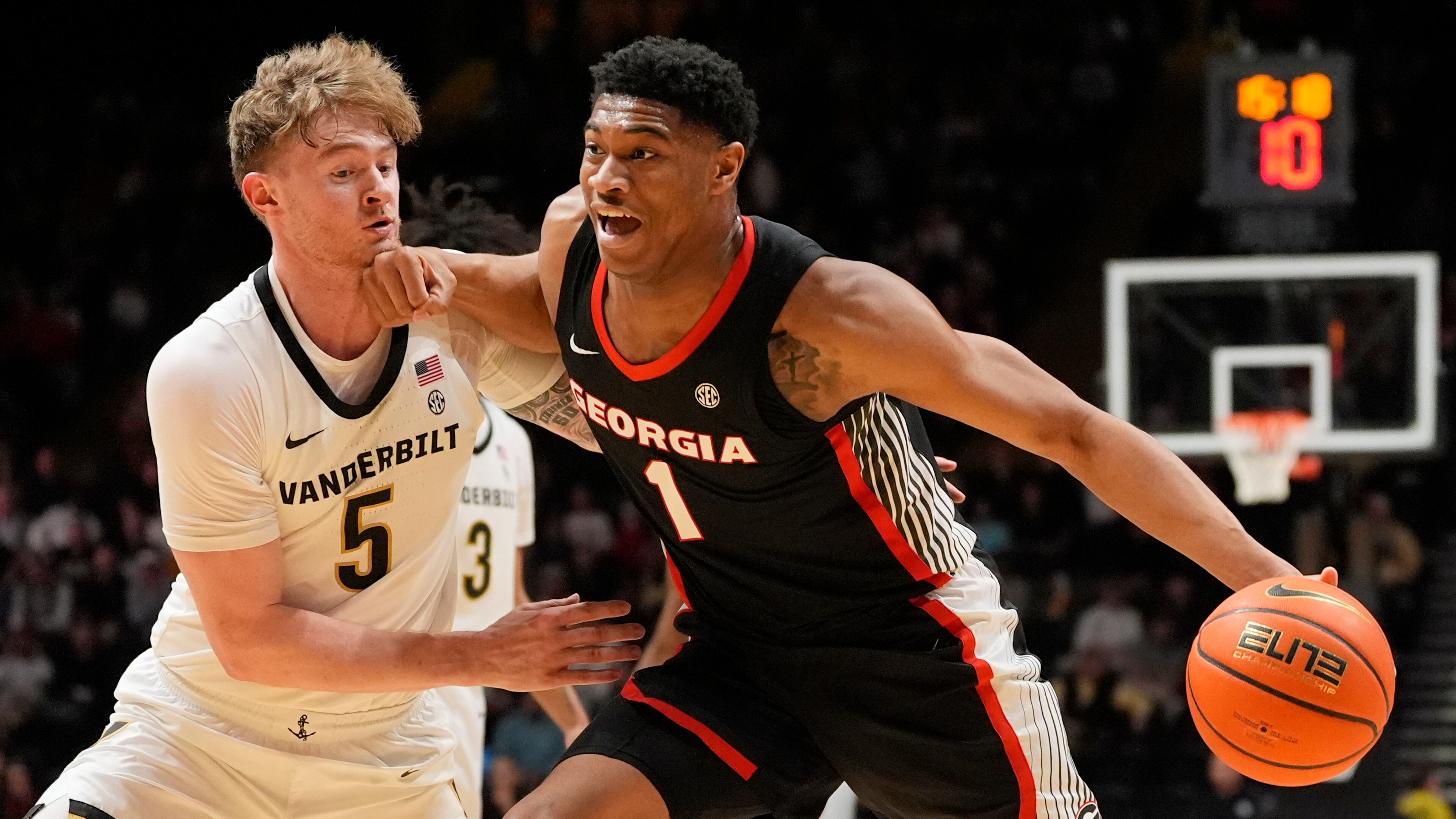Georgia forward Kareem Stagg (1) dribbles the ball past Vanderbilt forward Tyler Nickel (5) during the first half of an NCAA college basketball game Wednesday, Feb. 25, 2026, in Nashville, Tenn. (AP Photo/George Walker IV)