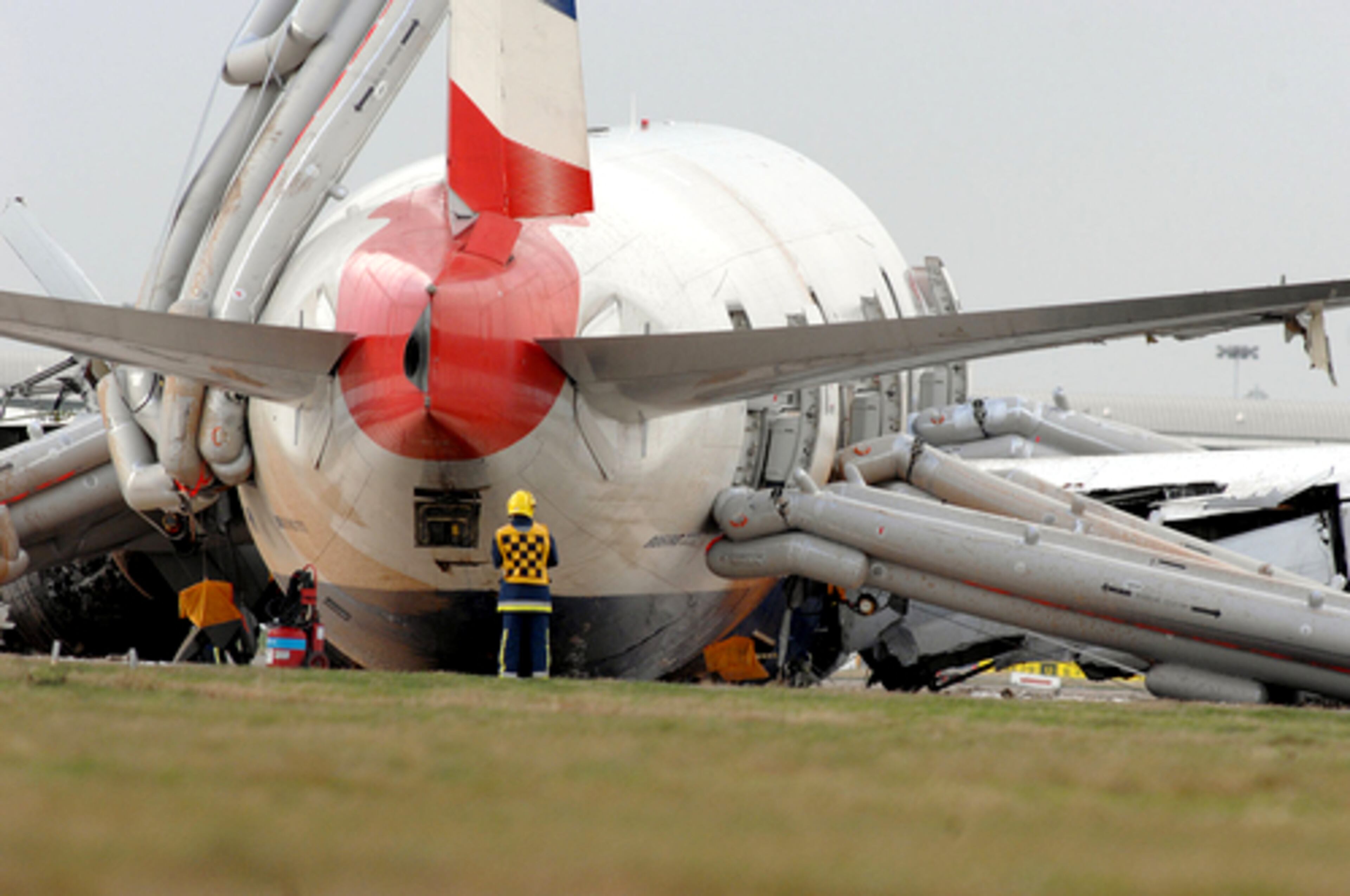 A British Airways passenger jet crash-landed just short of a runway at London's Heathrow airport on Thursday, plowing across open grassland before skidding to a halt when it hit the tarmac with parts of its undercarriage torn off.