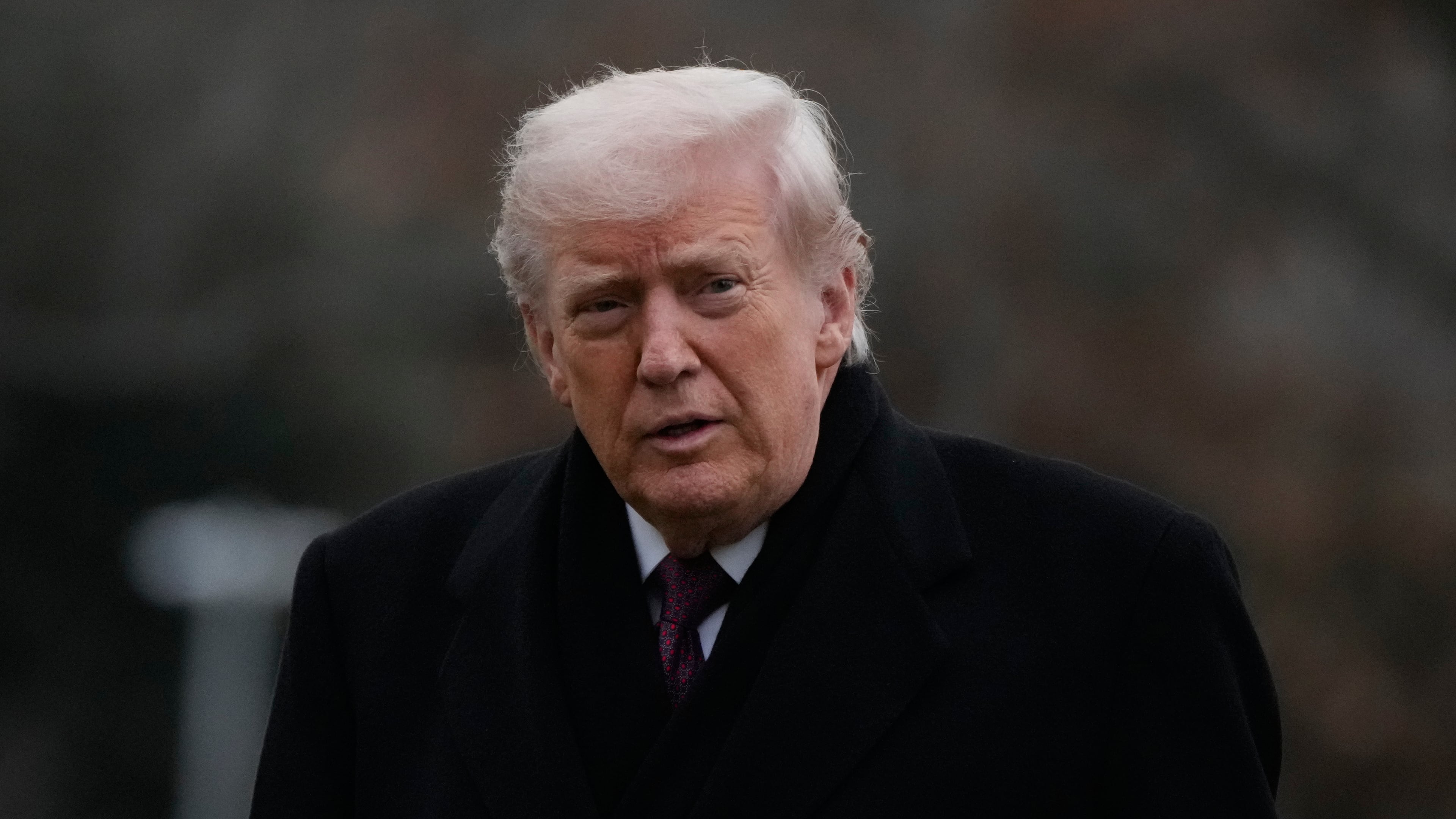 President Donald Trump looks over after stepping off Marine One on the South Lawn of the White House, Wednesday, Dec. 17, 2025, in Washington. (AP Photo/Mark Schiefelbein)