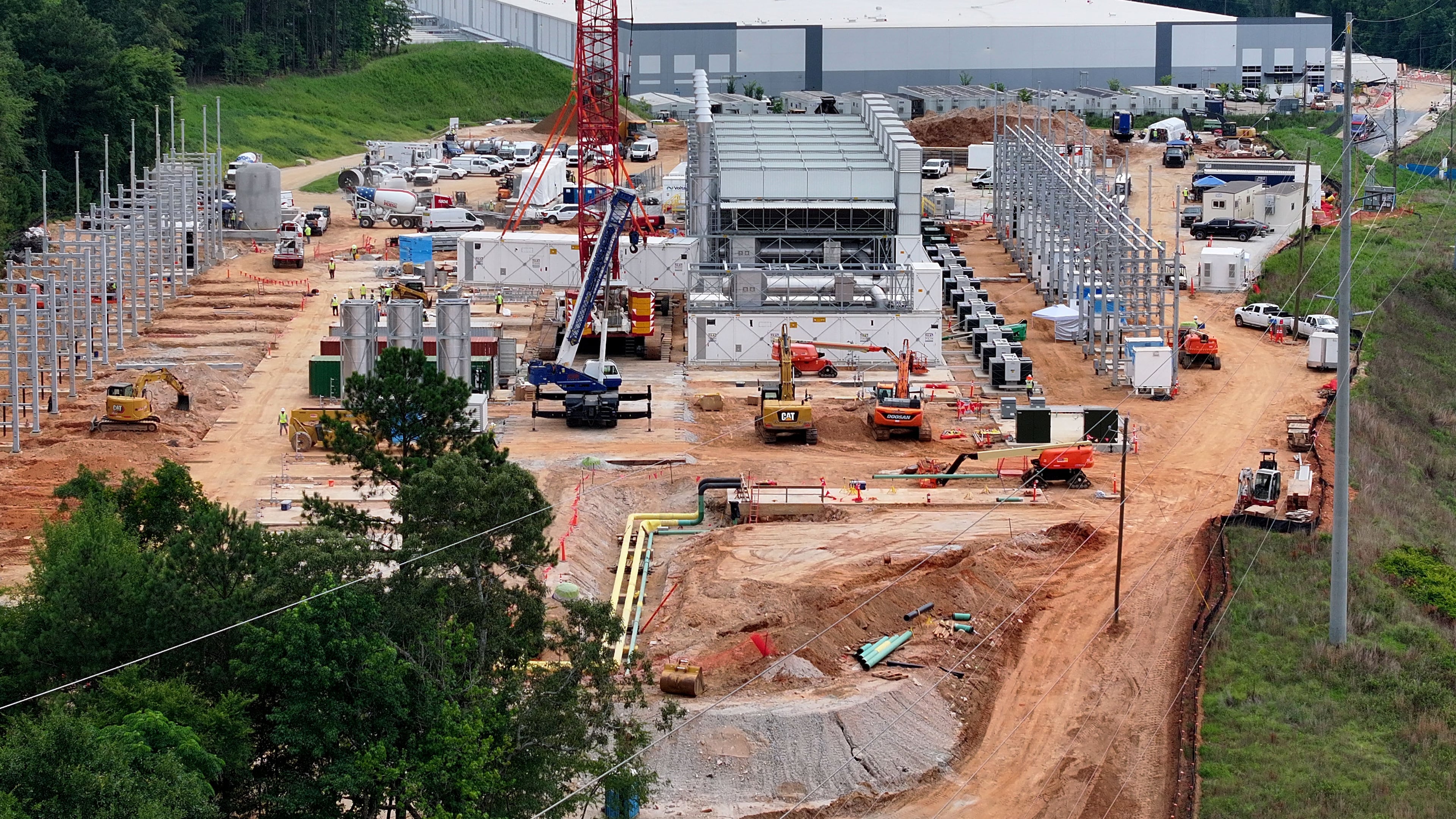 Aerial view of off-grid generators being installed, with the data center in the background, on Thursday, June 25, 2026, in Covington. A data center near Social Circle plans to get its primary power supply from a set of off-grid generators, the first setup of its kind in Georgia. But the company behind the power project is already installing its equipment, despite never obtaining proper permits from the state, a move environmental advocates say raises serious questions about oversight of data centers cropping up across Georgia. (Hyosub Shin/AJC)
