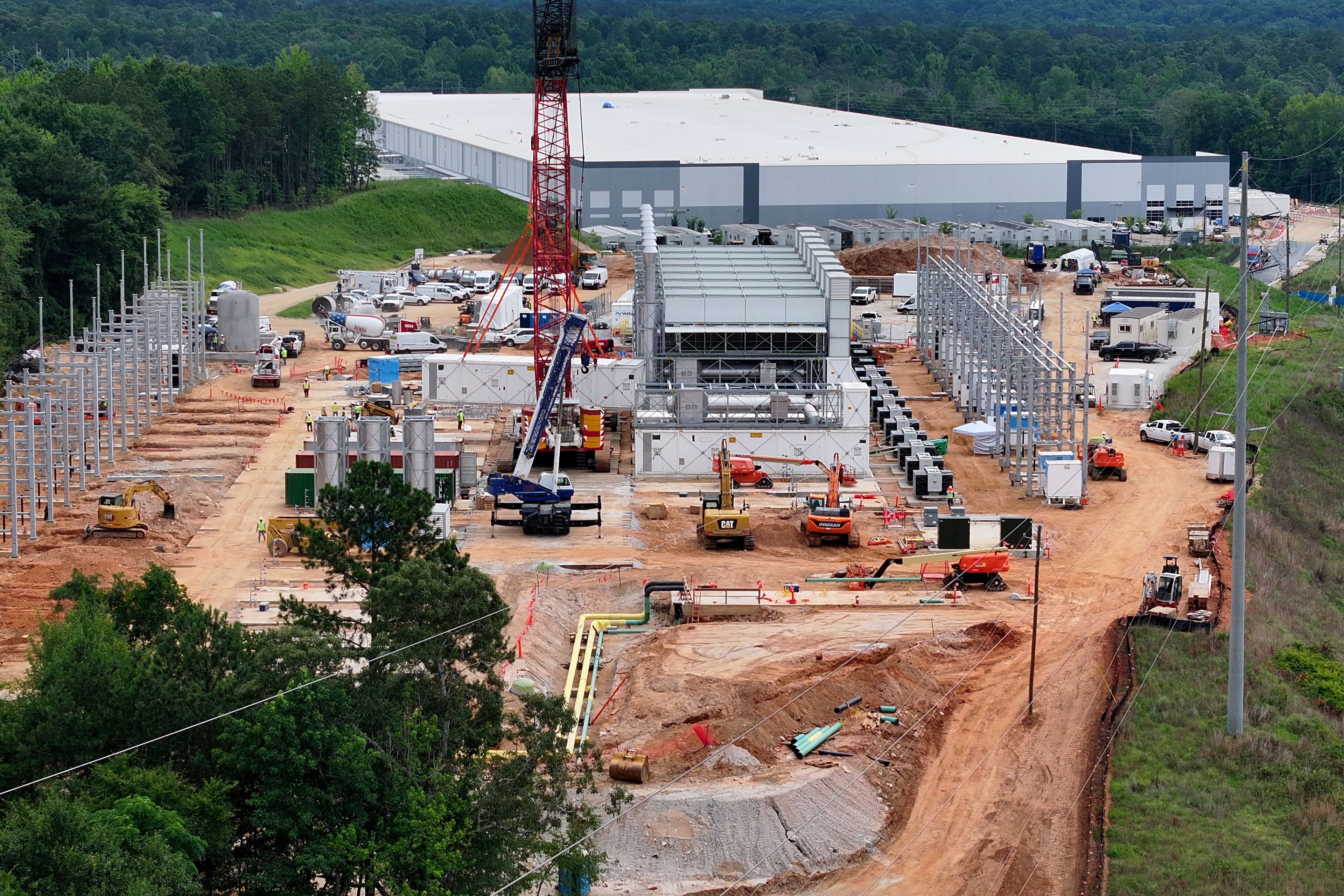Aerial view of off-grid generators being installed, with the data center in the background, on Thursday, June 25, 2026, in Covington. A data center near Social Circle plans to get its primary power supply from a set of off-grid generators, the first setup of its kind in Georgia. But the company behind the power project is already installing its equipment, despite never obtaining proper permits from the state, a move environmental advocates say raises serious questions about oversight of data centers cropping up across Georgia. (Hyosub Shin/AJC)