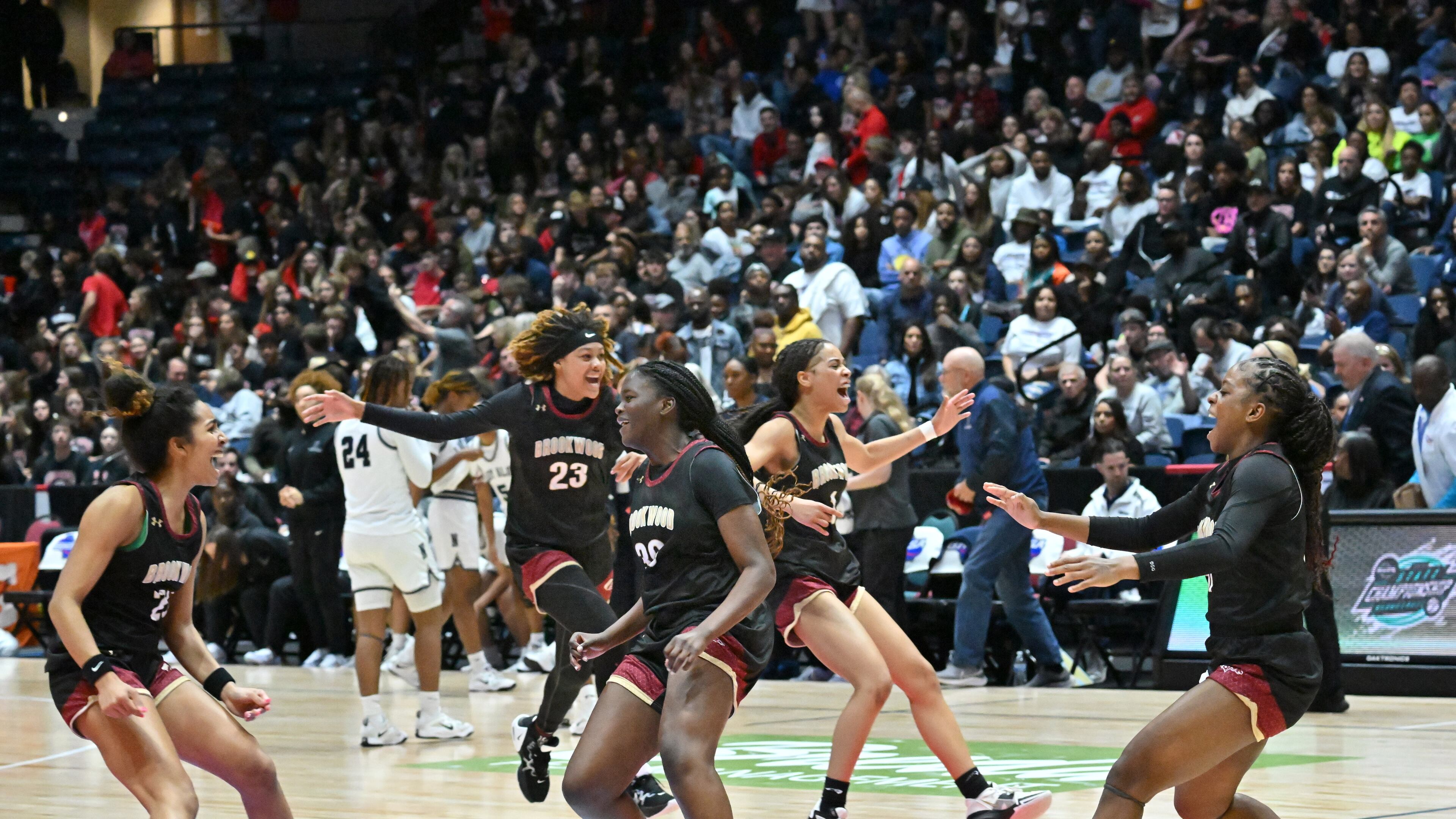 Brookwood players celebrate at the end of the 4th quarter during 2023 GHSA Basketball Class 7A Girl’s State Championship game at the Macon Centreplex, Saturday, March 11, 2023, in Macon, GA. (Hyosub Shin / Hyosub.Shin@ajc.com)