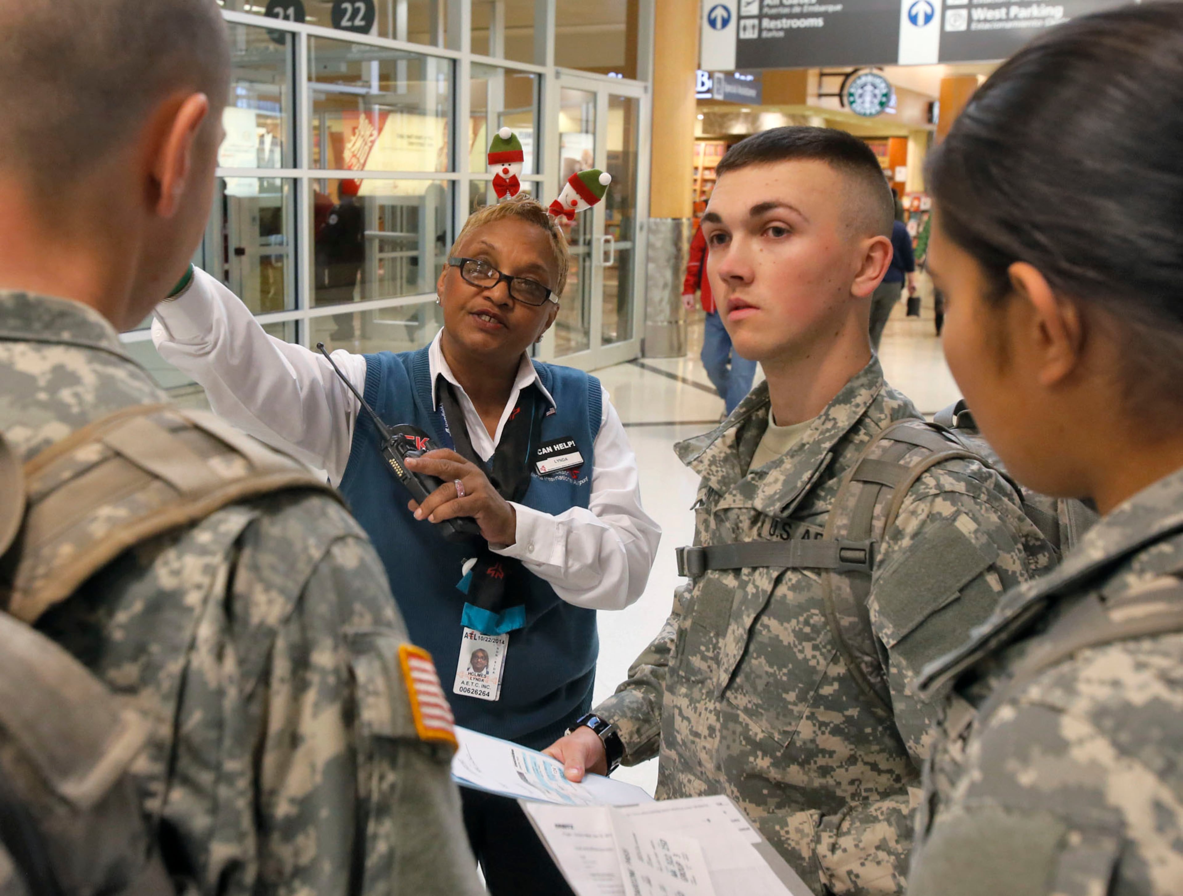 Linda Holmes,a customer care agent, directs soldiers to security and their gates.
