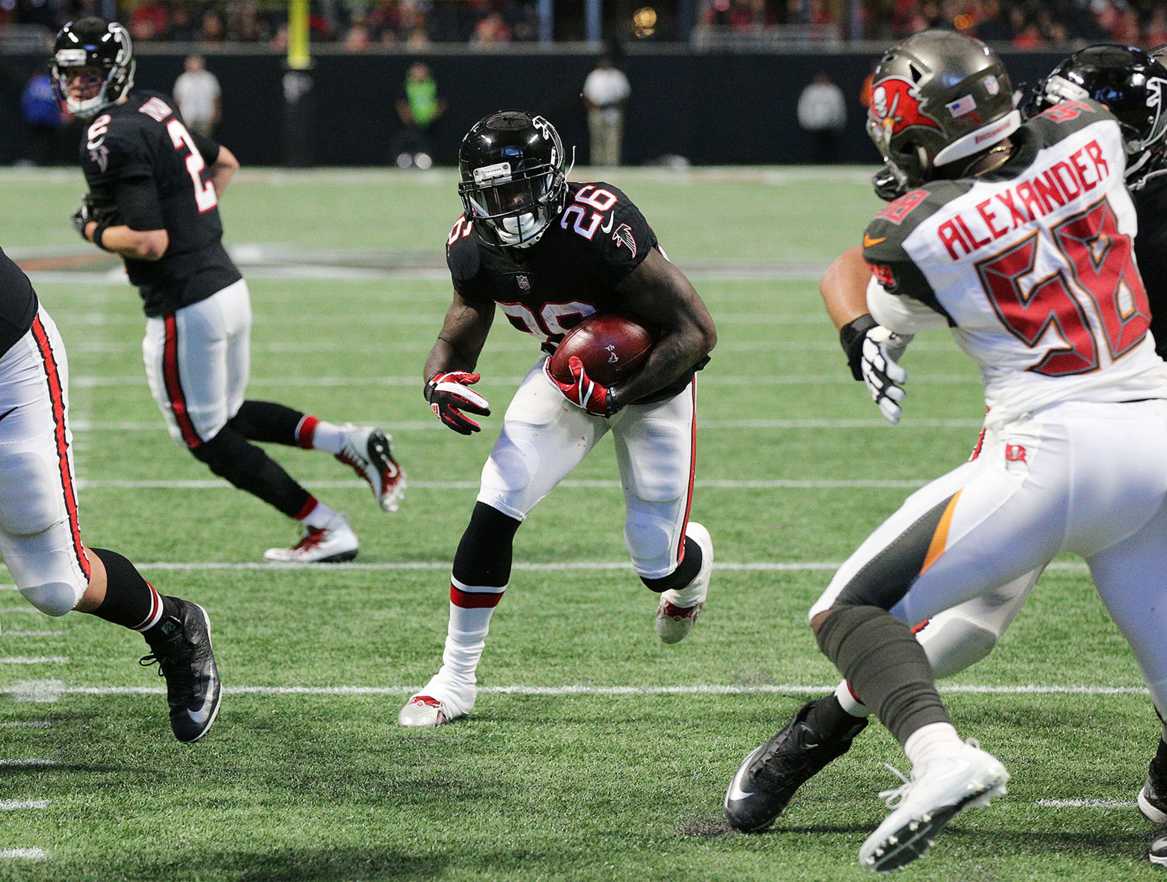 November 26, 2017 Atlanta: Falcons quarterback Matt Ryan hands off to running back Tevin Coleman who hits the hole for a touchdown to take a 27-6 lead over the Buccaneers during the third quarter in a NFL football game on Sunday, November 26, 2017, in Atlanta. Curtis Compton/ccompton@ajc.com