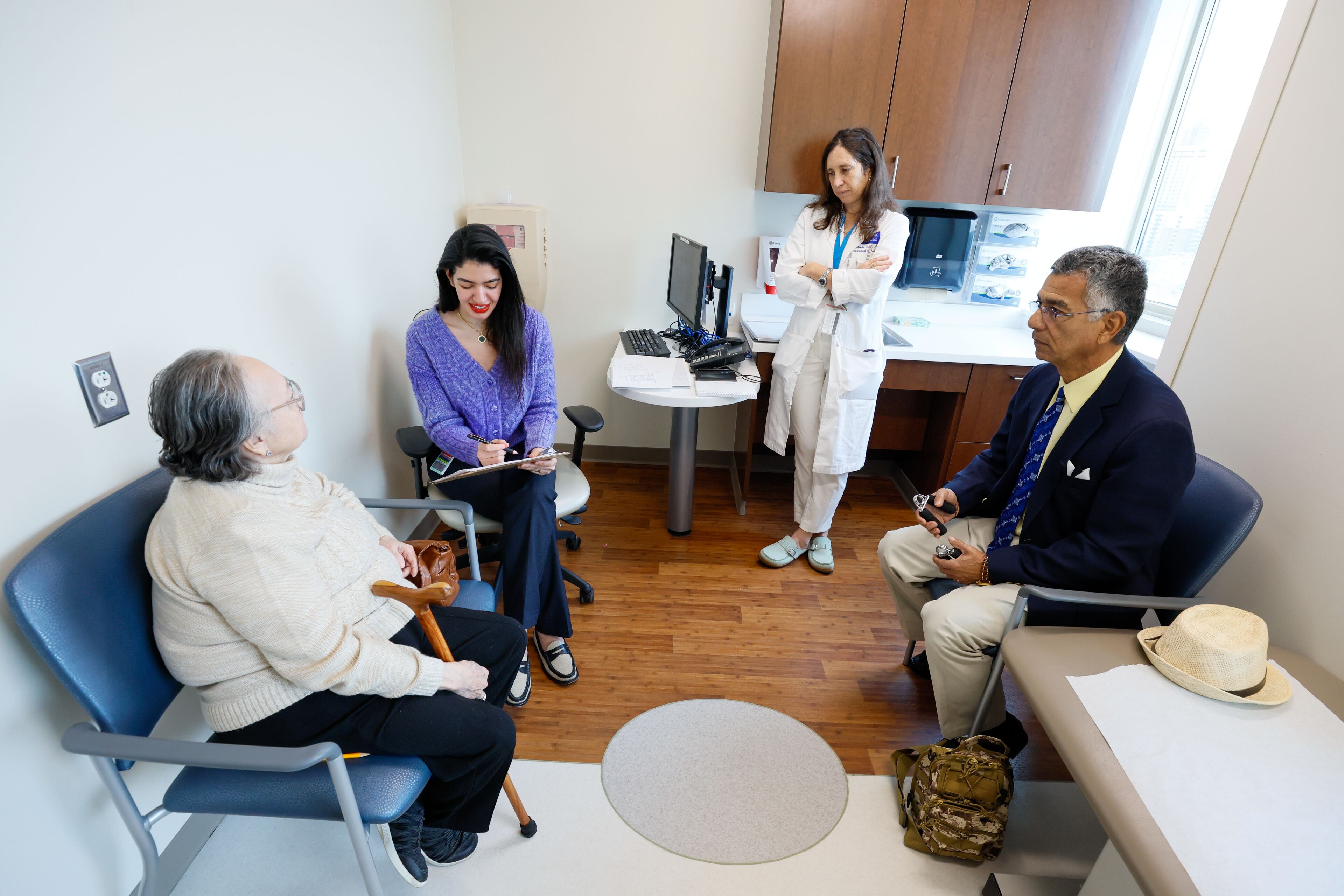 Patient at Georgia Memory Net Clinic at Grady Memorial Hospital. Beatriz Patiño (left) gets assistance from Dania Naser (second left) and Dr. Gabriela Cohen as they work on a cognitive assessment as her husband Jairo Patiño looks on Monday, Nov. 20, 2023.
Miguel Martinez /miguel.martinezjimenez@ajc.com