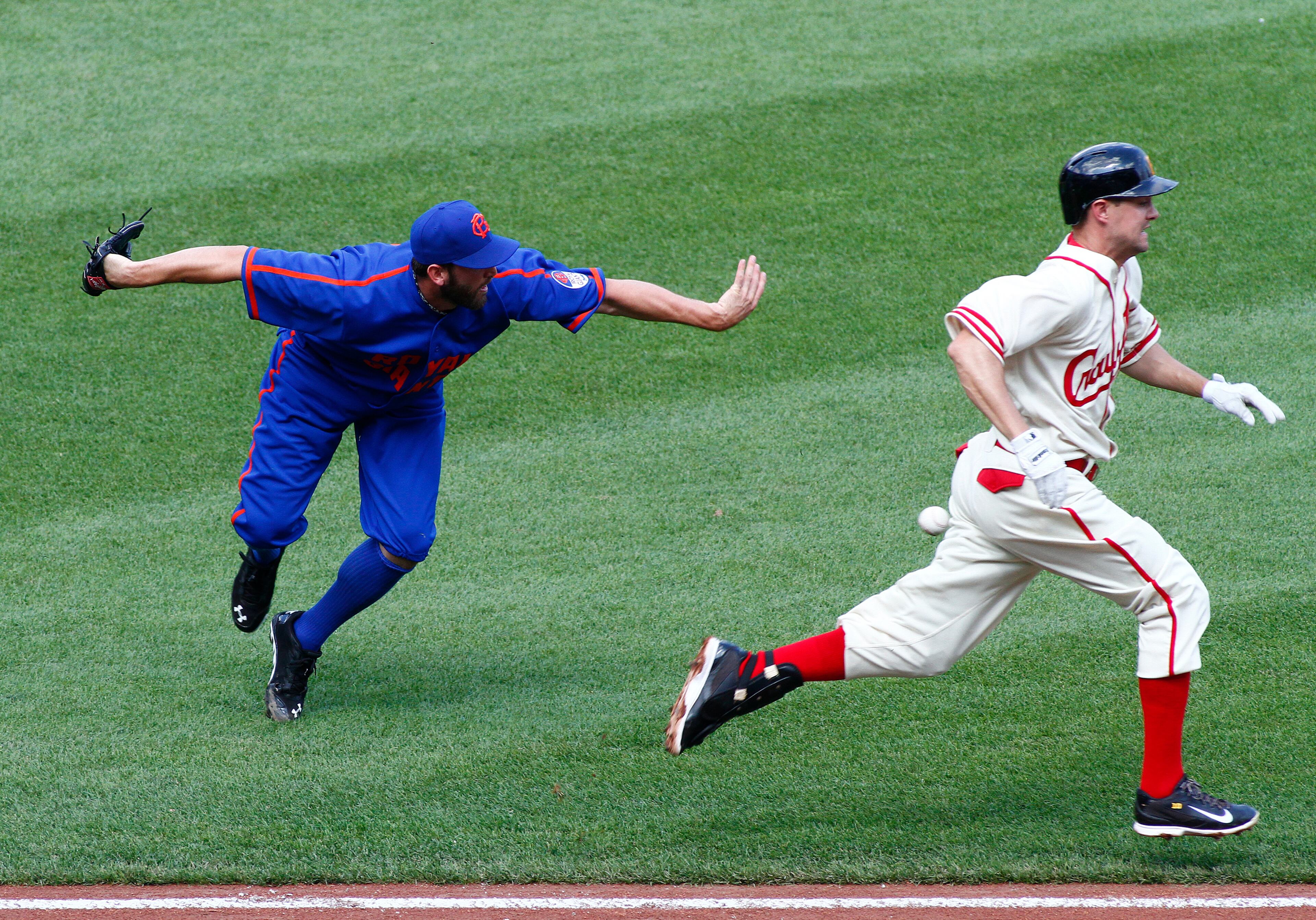 Jordy Mercer of the Pittsburgh Pirates reaches on a infield single during the first inning on a throwing error by Jonathon Niese of the New York Mets at PNC Park on June 28, 2014 in Pittsburgh. The Mets and the Pirates wear Negro League uniforms as a tribute to the Negro Leagues during a Negro League Heritage Game. The Mets wear uniforms honoring the Brooklyn Royal Giants and the Pirates honor the Pittsburgh Crawfords. (Photo by Justin K. Aller/Getty Images)