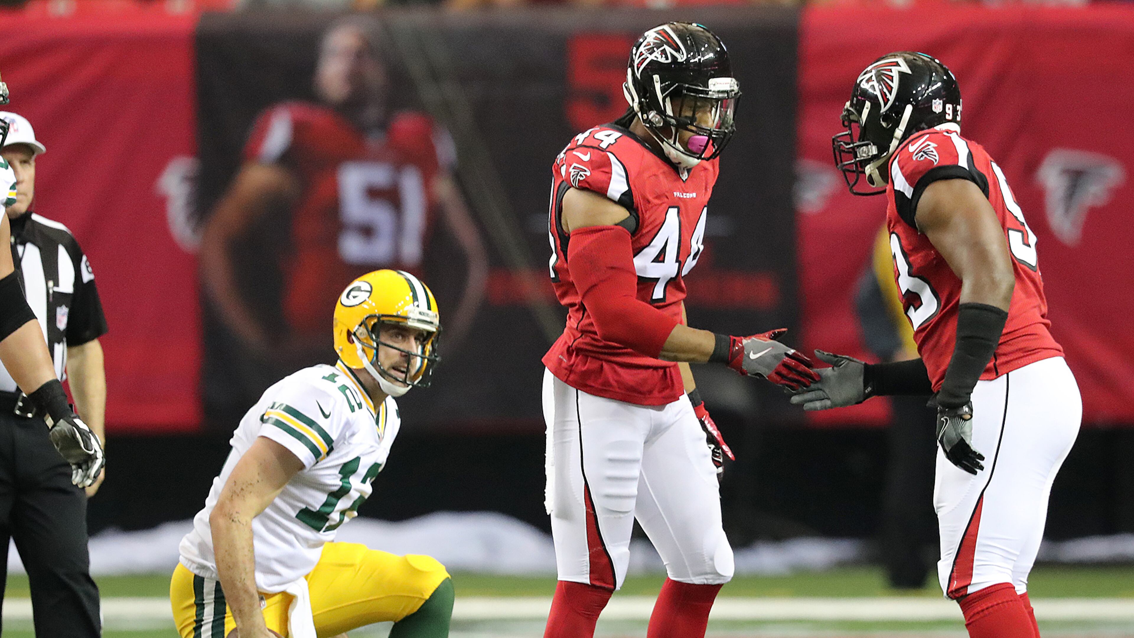 Falcons edge rusher Vic Beasley Jr. celebrates sacking Green Bay quarterback Aaron Rodgers with Dwight Freeney in the first half of a game Oct. 30. Beasley led the NFL with 15.5 sacks during the regular season. (Curtis Compton/ccompton@ajc.com)
