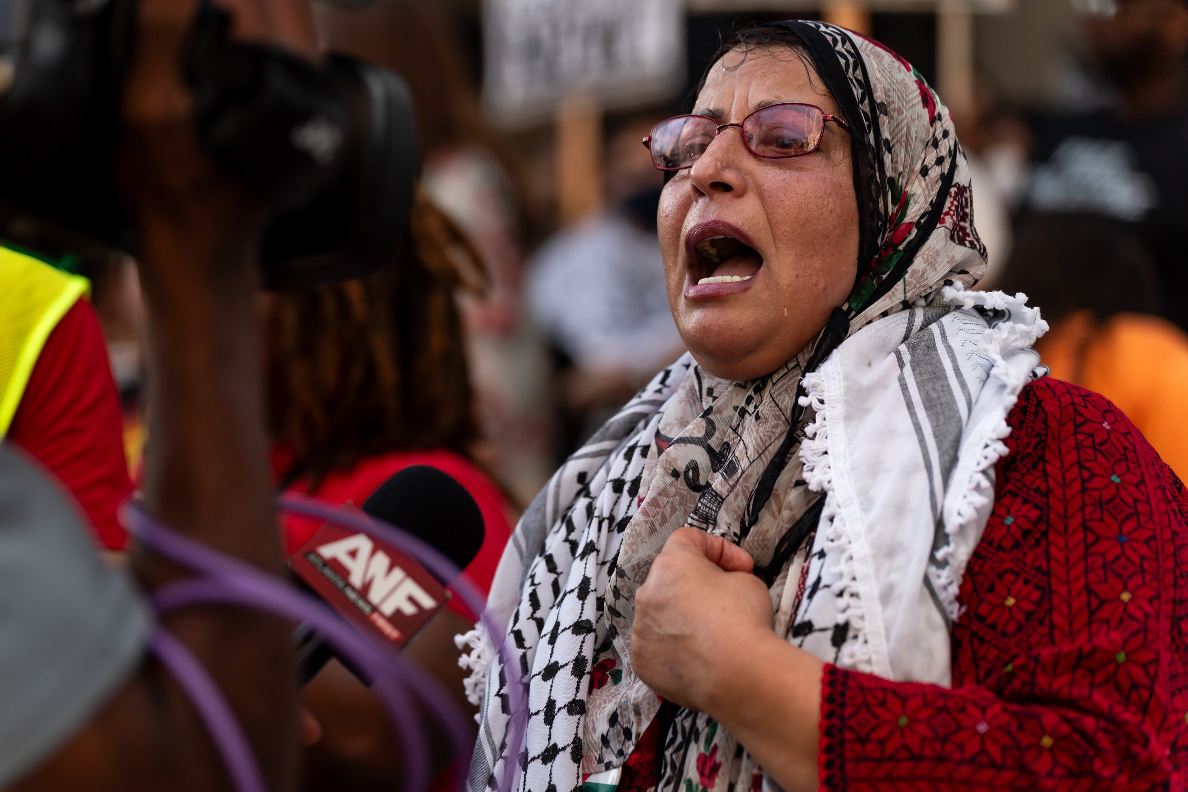 Jawahir Kamil speaks to reporters at a pro-Palestinian protest near the intersection of 10th Street NW and Spring Street NW in Atlanta on Thursday, June 27, 2024. Nearby, President Joe Biden and former President Donald Trump participated in a debate hosted by CNN. (Seeger Gray / AJC)