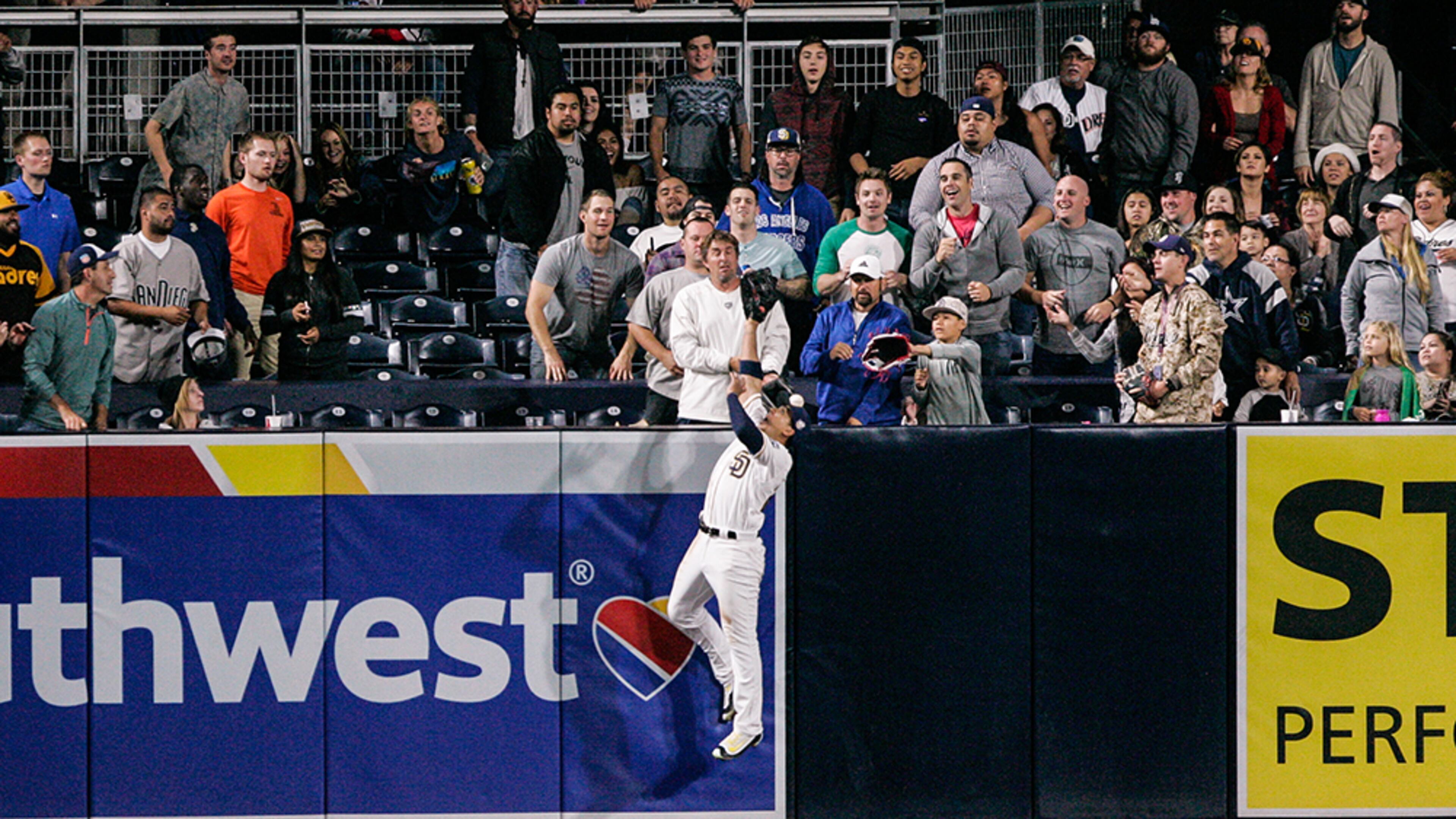 San Diego Padres outfielder Jon Jay jumps at the wall as the ball hit by Braves' Freddie Freeman bounces back to the field in the ninth inning at PETCO Park June 7, 2016, in San Diego.