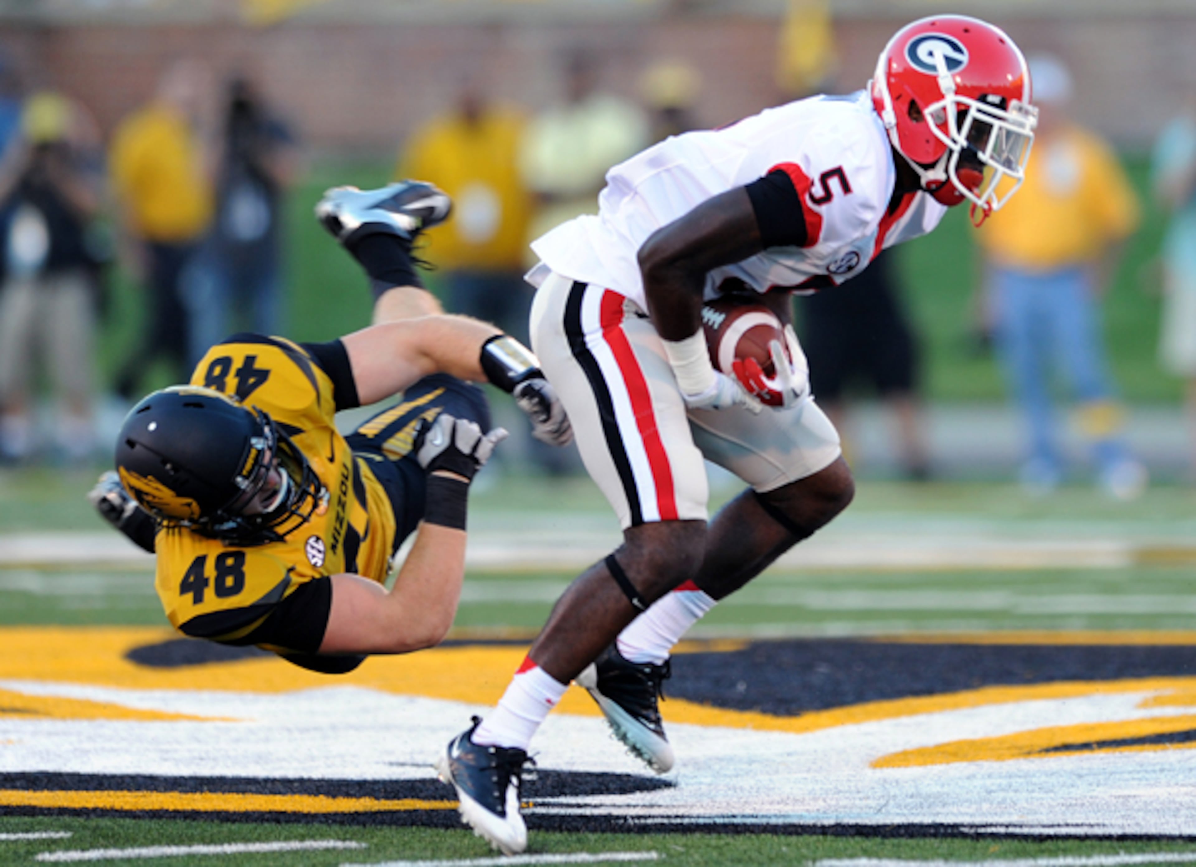Georgia's Damian Swann eludes the tackle of Missouri's Andrew Wilson during a punt return.