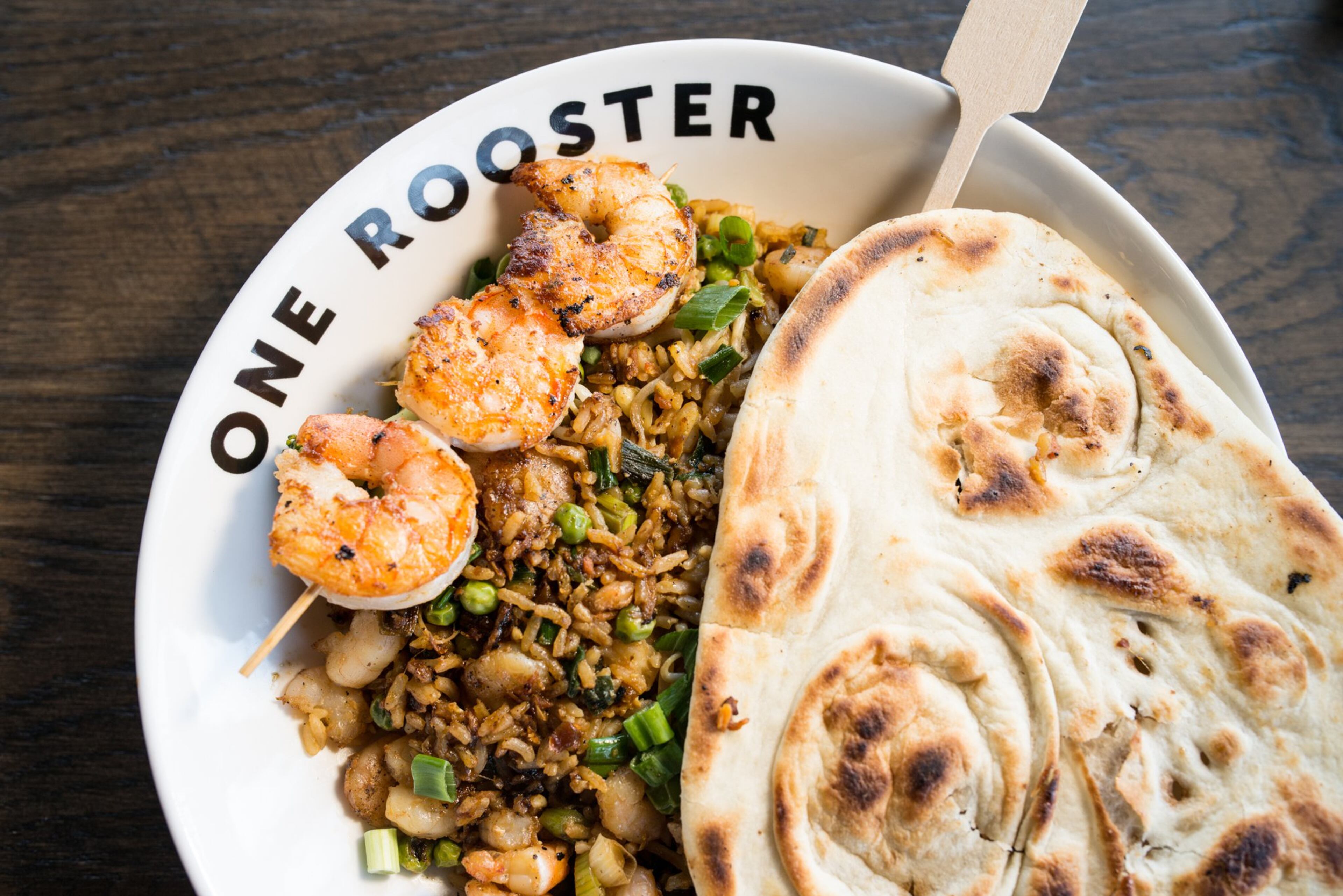 One Rooster Brown Rice bowl with Mongolian sauce, seared prawns, veggies, and naan bread. Photo credit - Mia Yakel.