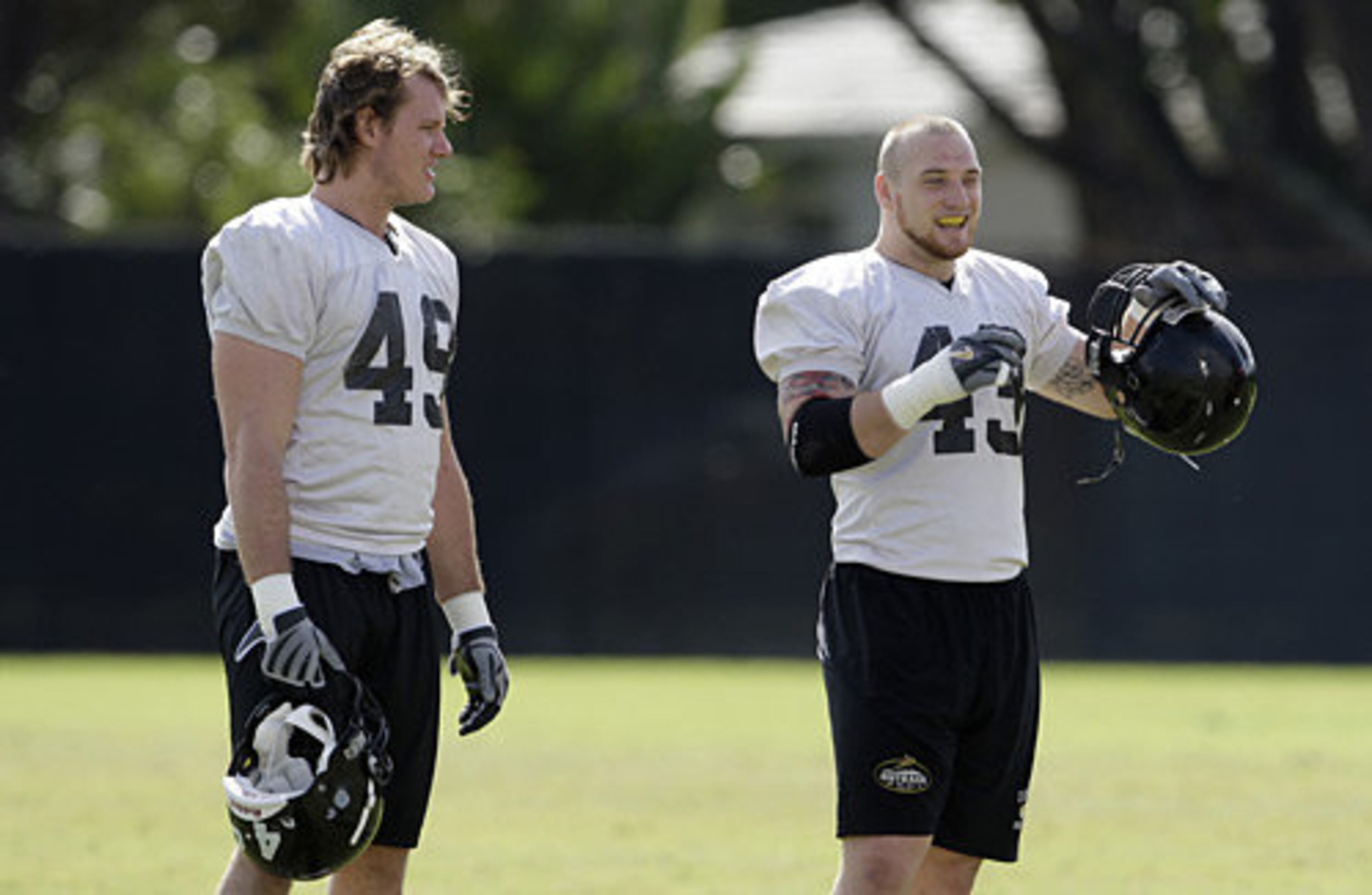 Iowa linebackers A.J. Edds (49) and Pat Angerer (43) prepare to do drills.