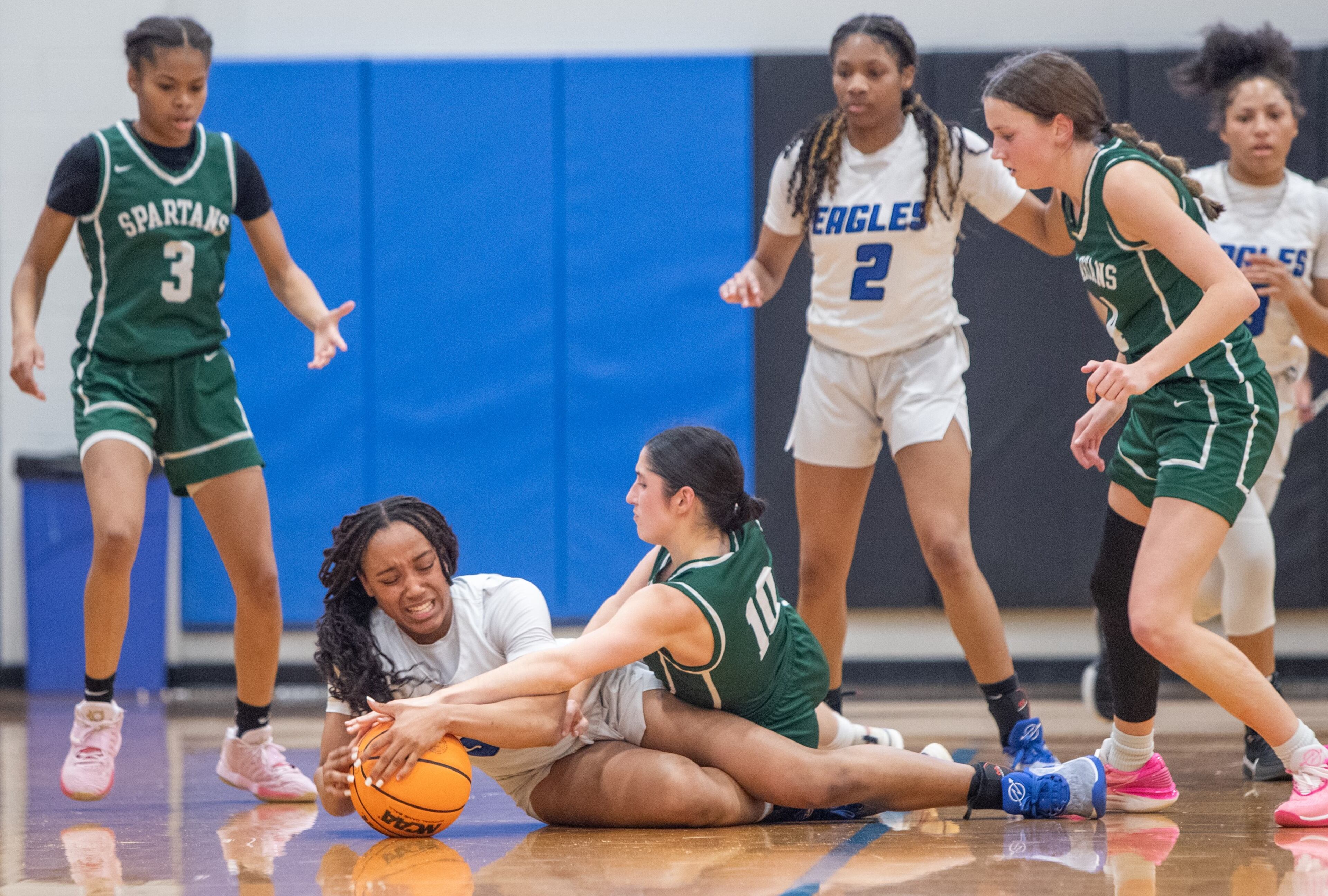 Mount Paran Christian School’s Jasiah Washington (on ground left) struggles for ball control against Josie Collins of Athens Academy in first half action during Friday's game in Kennesaw. Mount Paran advanced to the next round with the 77-34 victory. (Jenni Girtman for The Atlanta Journal-Constitution)