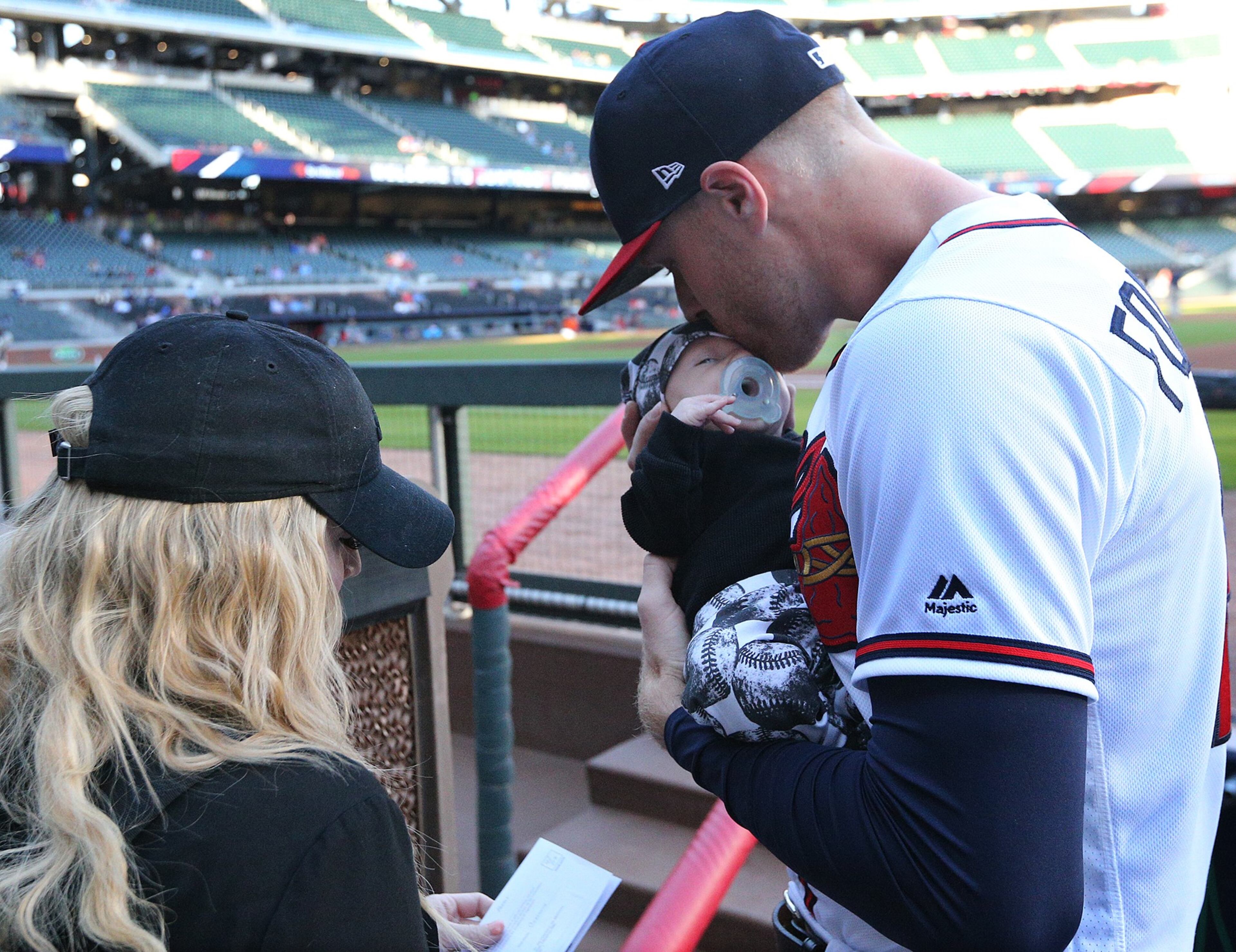 April 17, 2018 Atlanta: Braves starting pitcher Mike Foltynewicz kisses his 2-month old son Jett in the dugout before taking the mound to play the Phillies in a MLB baseball game on Tuesday, April 17, 2018, in Atlanta. Curtis Compton/ccompton@ajc.com