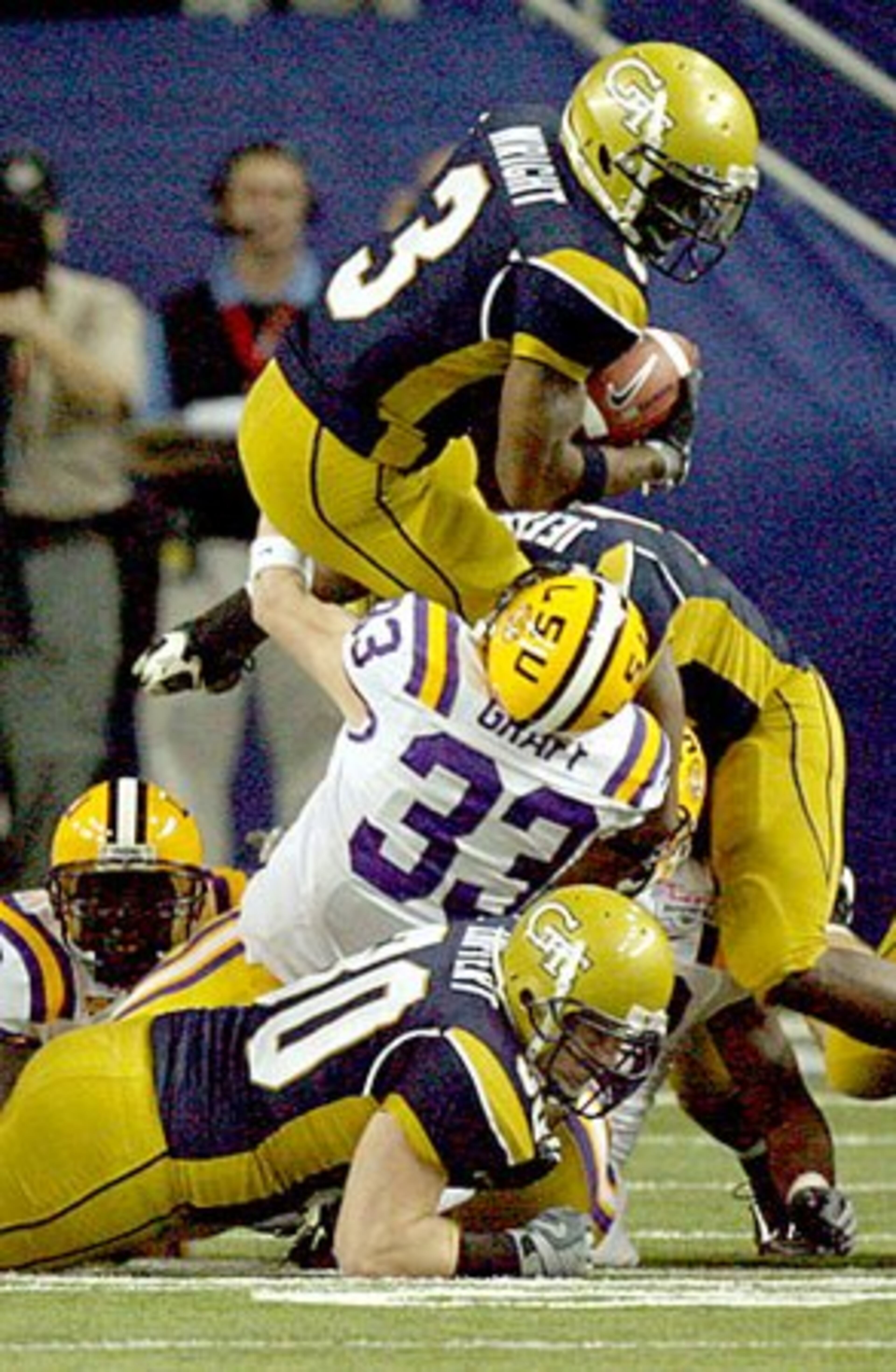 Tech's Marcus Wright (3) is pulled down by LSU's Daniel Graff during a punt return.