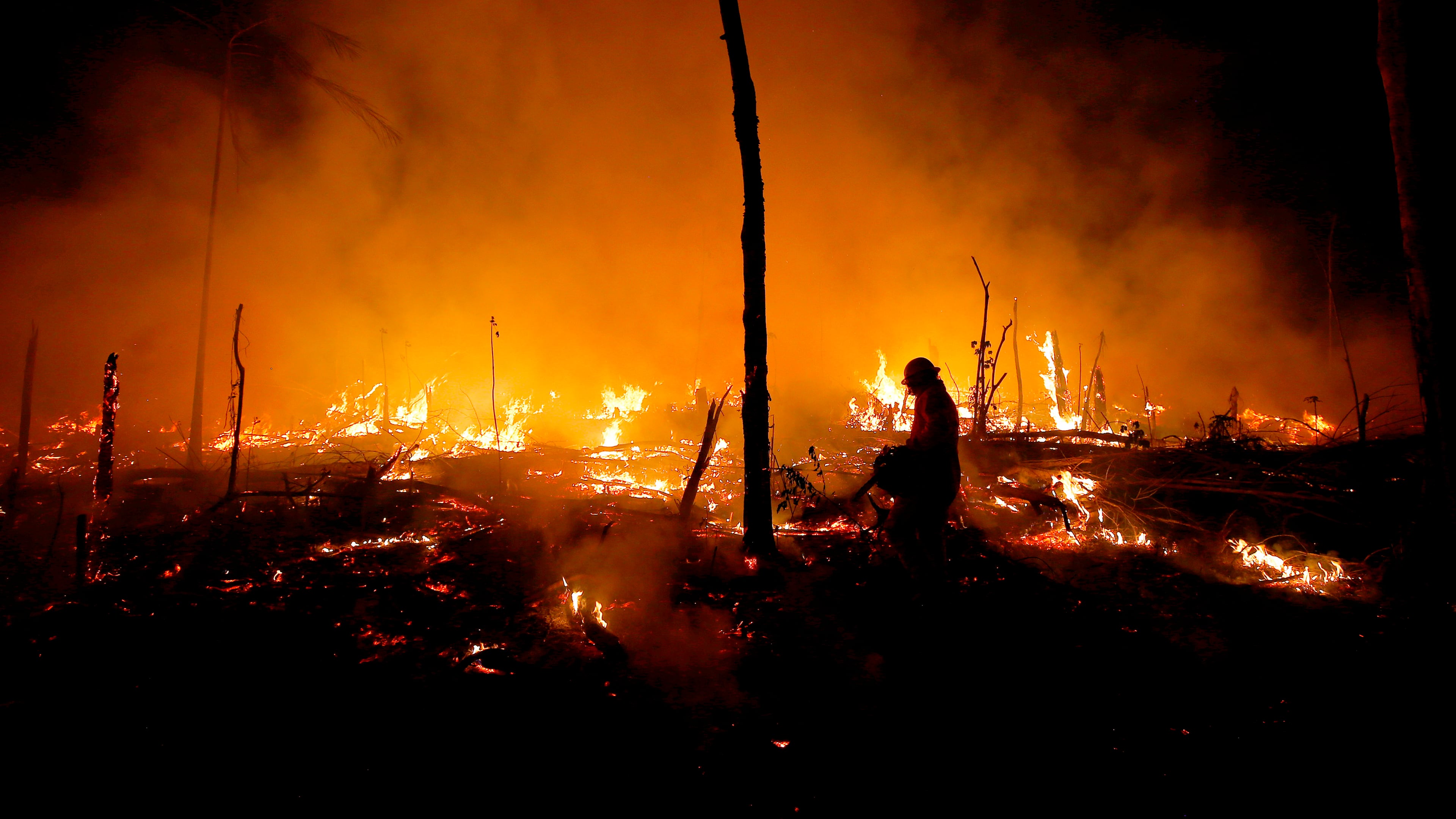 FILE - Firefighters work to put out a blaze in the Amazon forest during a drought and high temperatures in the rural municipality of Careiro Castanho, Amazonas state, Brazil, Oct. 21, 2023. (AP Photo/Edmar Barros, File)
