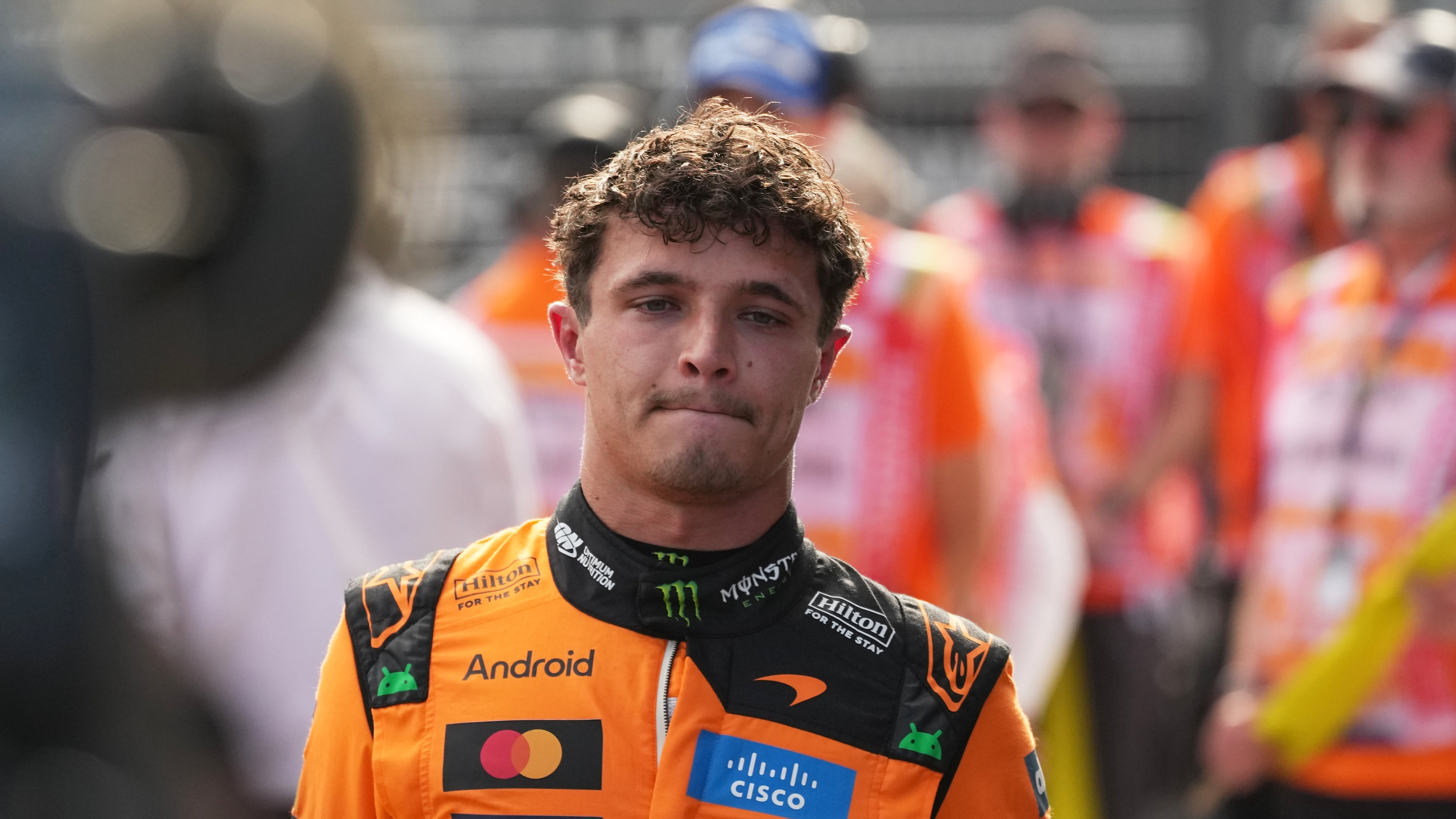 McLaren driver Lando Norris of Britain walks after winning the qualifying session ahead of Sunday's Formula One Hungarian Grand Prix auto race, at the Hungaroring racetrack in Mogyorod, near Budapest, Hungary, Saturday, July 25, 2026. (AP Photo/Darko Vojinovic)