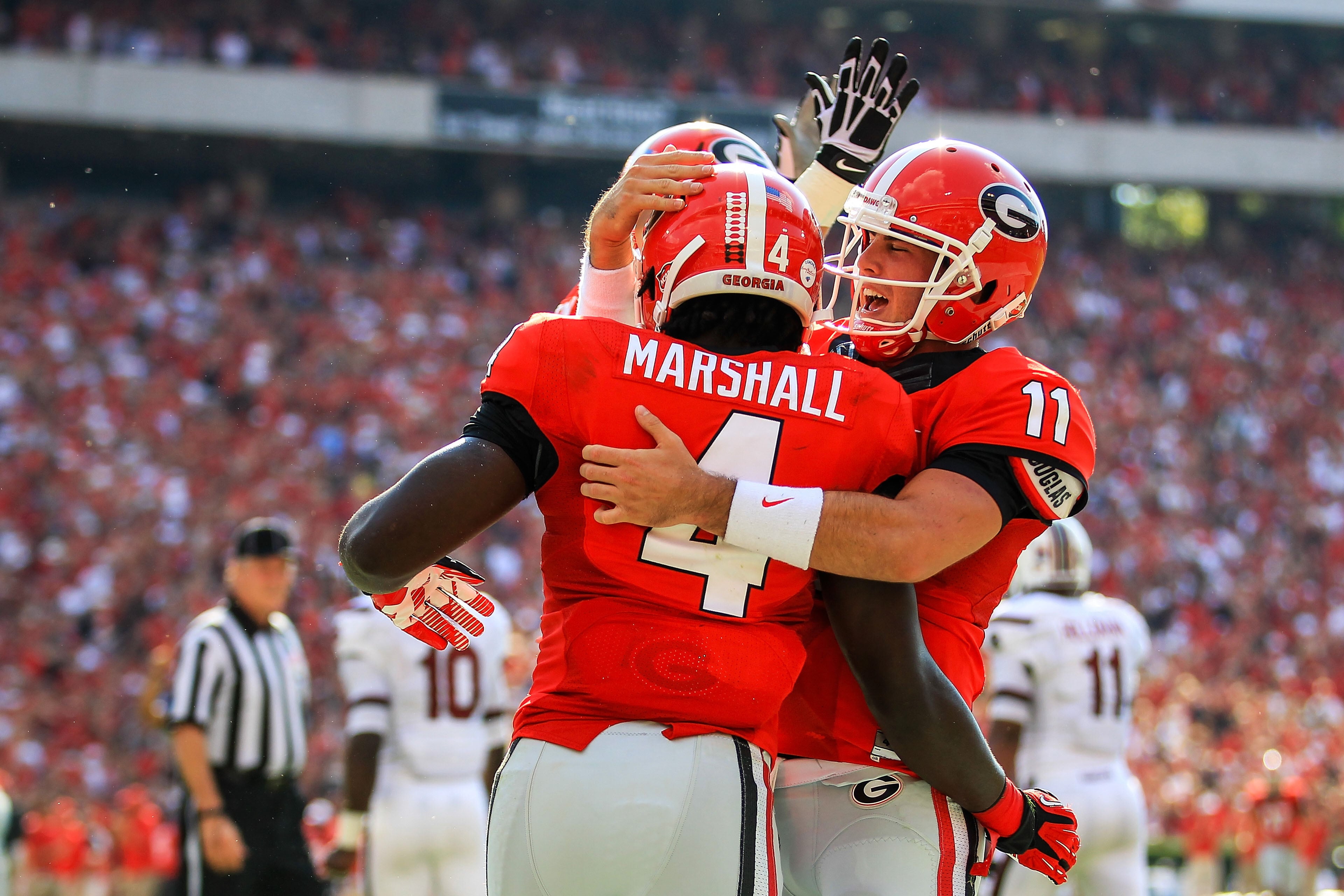 Georgia running back Keith Marshall (4) celebrates a touchdown with quarterback Aaron Murray (11) and offensive tackle Kolton Houston (75) against South Carolina. Daniel Shirey-USA TODAY Sports