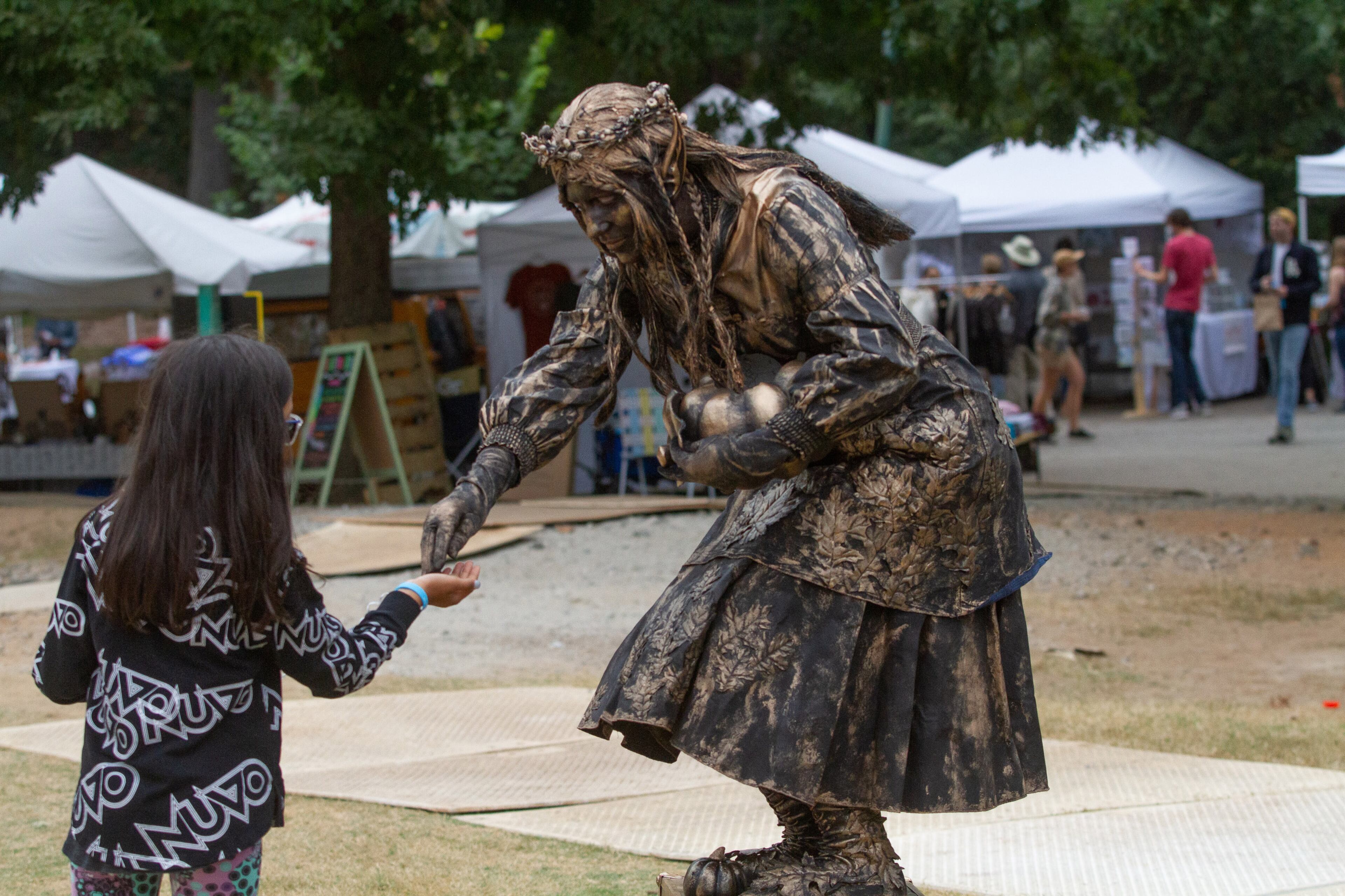 The Autumn Elf performs for passersby during the Candler Park Fall Fest 2019 in Atlanta on Sunday, October 6, 2019. STEVE SCHAEFER / SPECIAL TO THE AJC