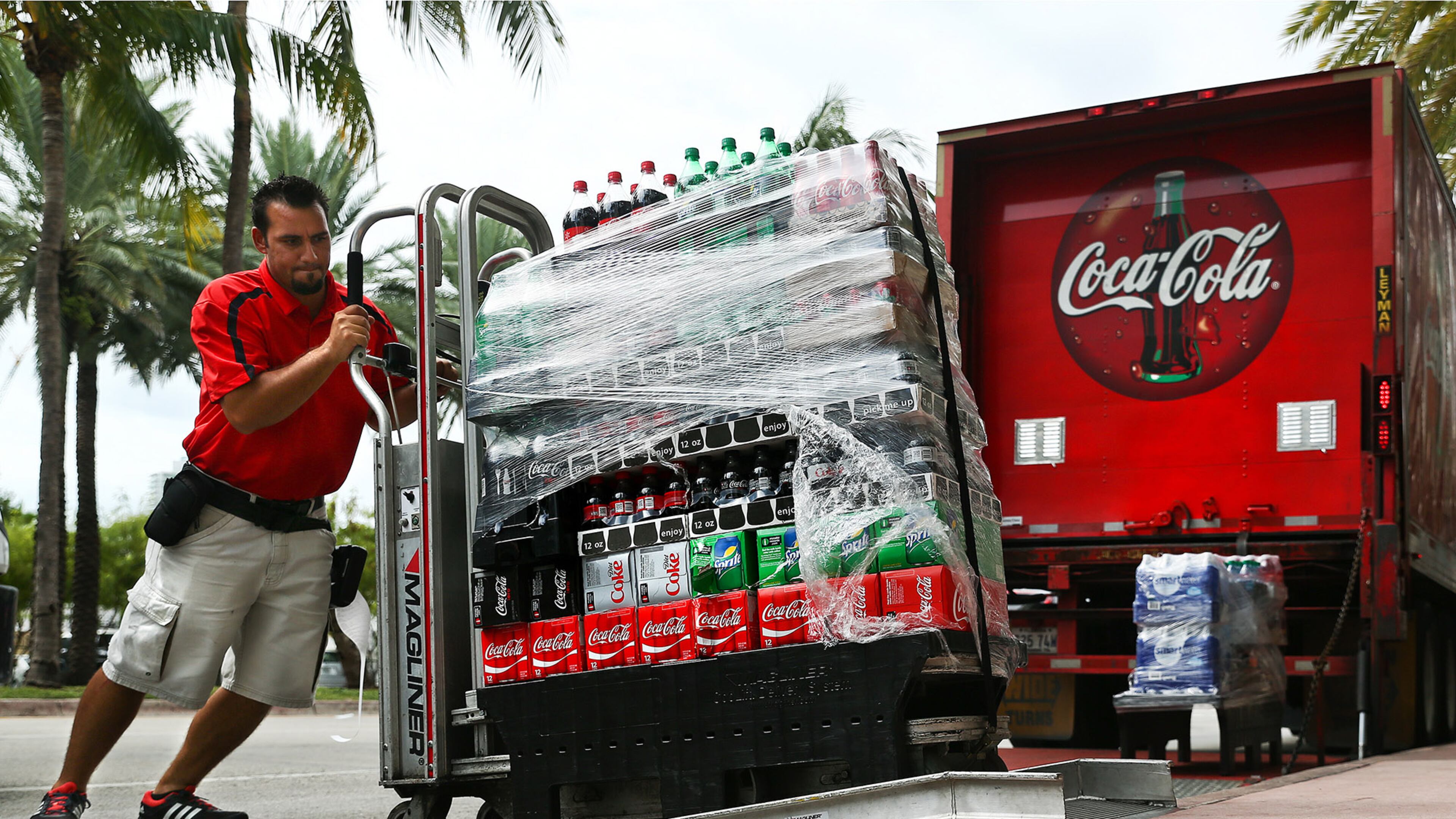 Scott McIntyre/Bloomberg An employee delivers cases of Coca-Cola brand sodas in Miami Beach, Florida, on Oct. 24, 2016. (MUST CREDIT: Scott McIntyre/Bloomberg)