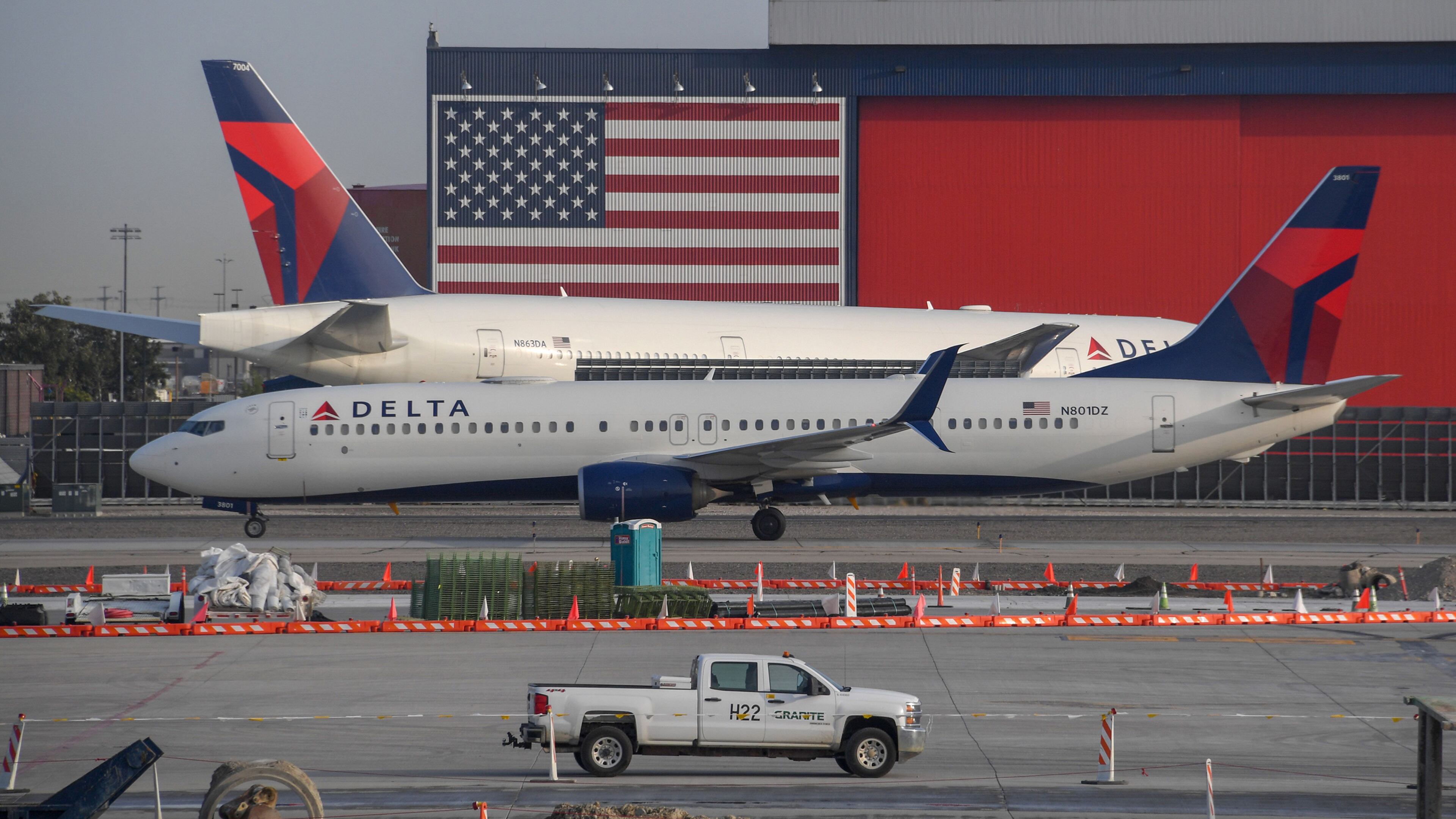 A Delta Airlines Boeing 737, front, passes another Delta Airlines Boeing 777 on the tarmac at Salt Lake City International Airport, Sept. 16, 2020. (Robyn Beck/AFP/Getty Images/TNS)