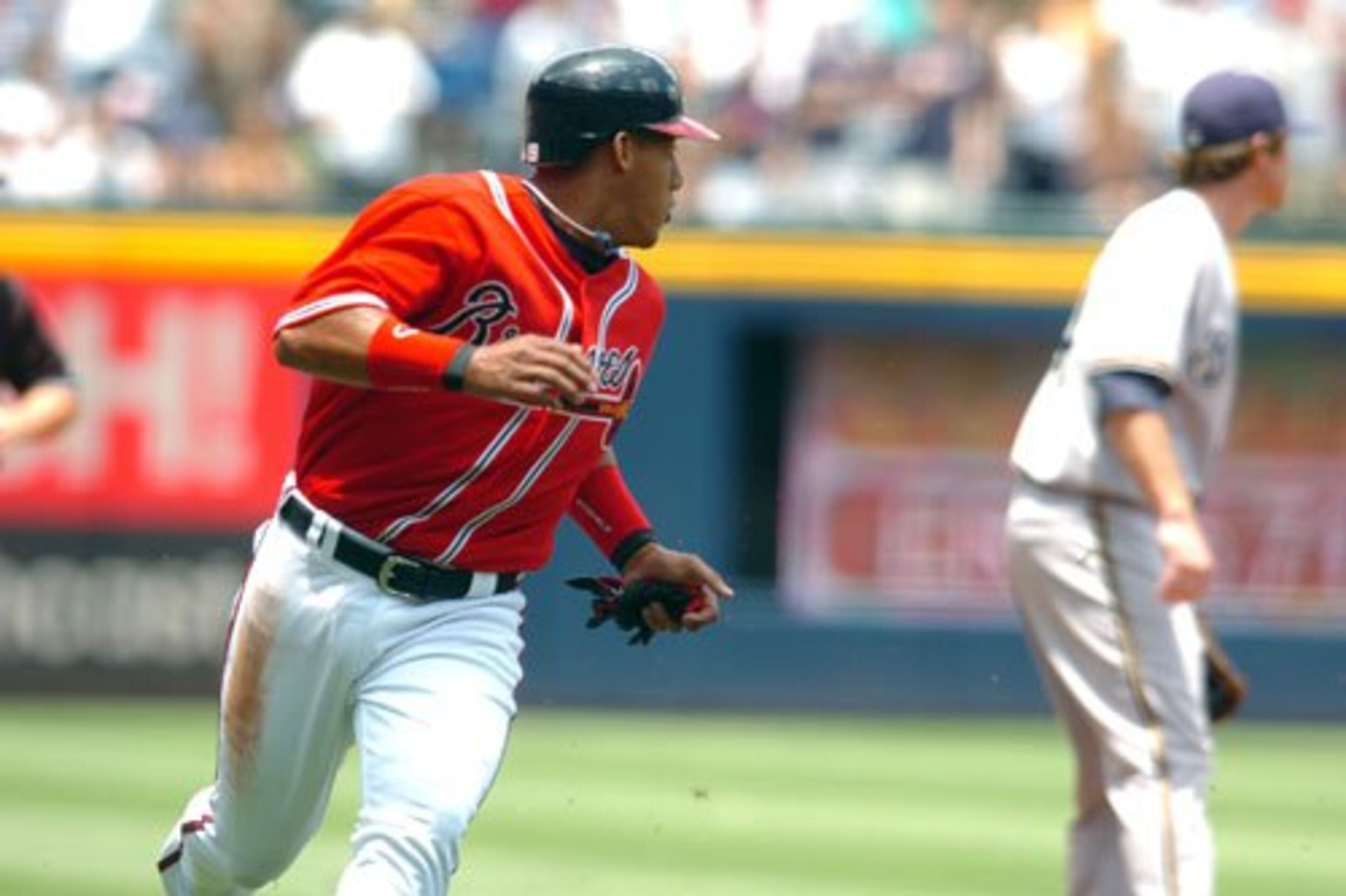 Braves shortstop Yunel Escobar rounds third on his way to score in the first inning.