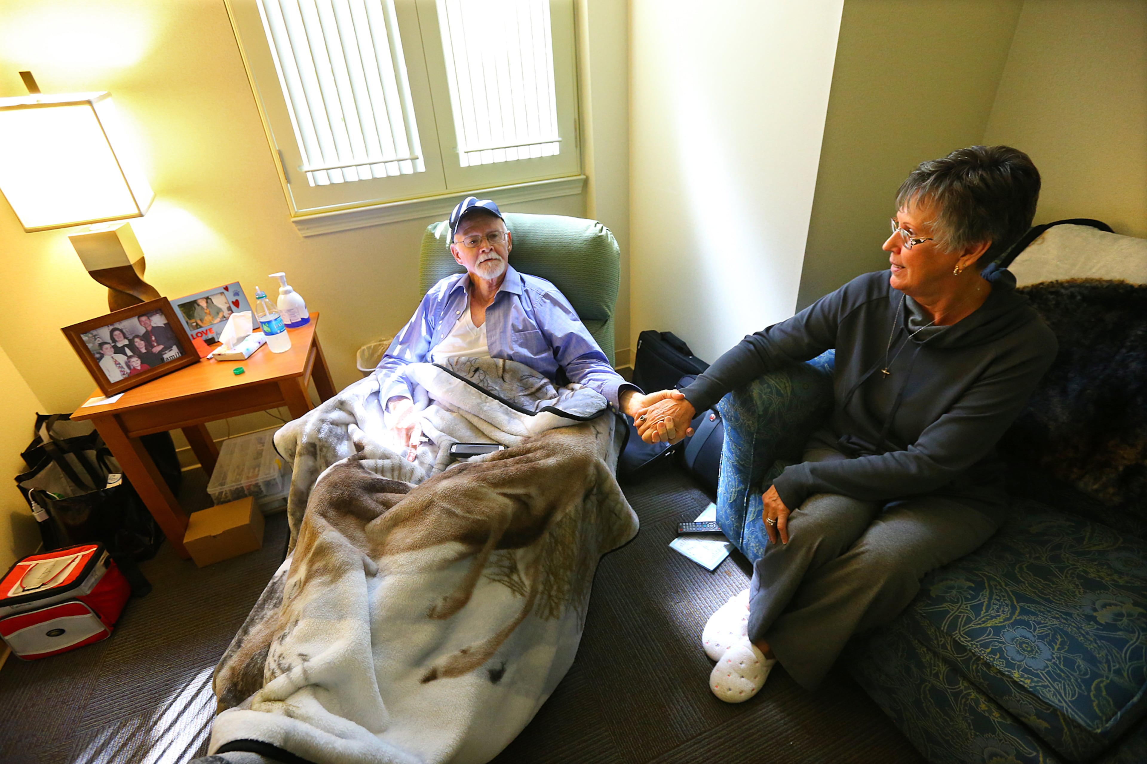 100514 DECATUR: Following a chemotherapy treatment for throat cancer, James W. Bailey, 71, Cleveland, TN, recovers in his room at the Atlanta Hope Lodge with his wife Barbara Bailey at his side on Sunday, Oct. 5, 2014, in Decatur. The American Cancer Society's Hope Lodge provides free lodging to patients going through cancer treatment. Bailey said "its been a great blessing for us. We had no idea what we were going to do. Its too much to get up every day and travel back and forth to treatment and we can't afford to rent a place for 7 weeks." CURTIS COMPTON / CCOMPTON@AJC.COM