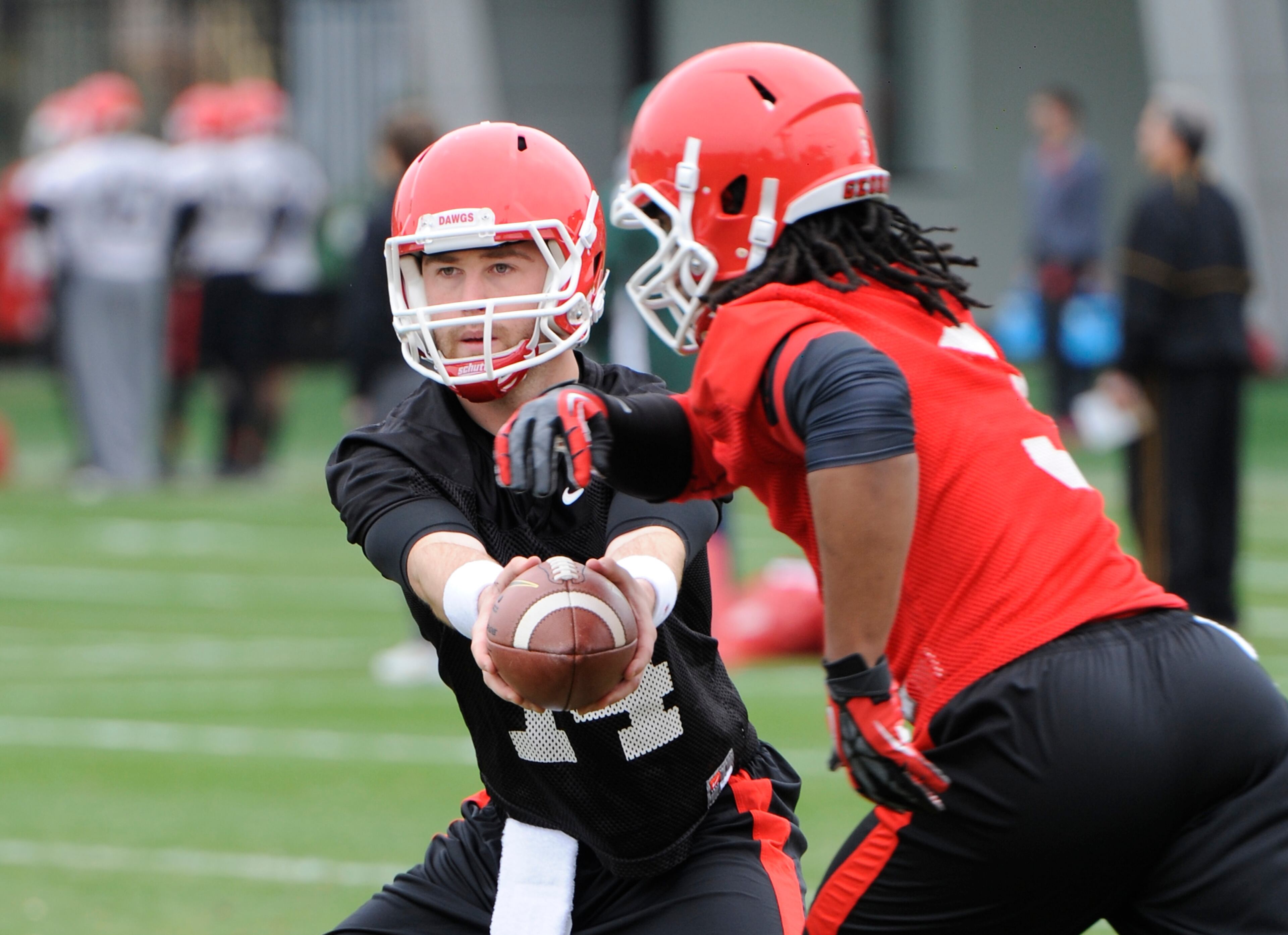 Quarterback Hutson Mason (14) hands the ball to Tailback Todd Gurley (3) during Georgia's first day of Spring Practice at the Woodruff practice fields on Tuesday, Mar.18th. 2014 in Athens, Ga. ( Photo by John Kelley )