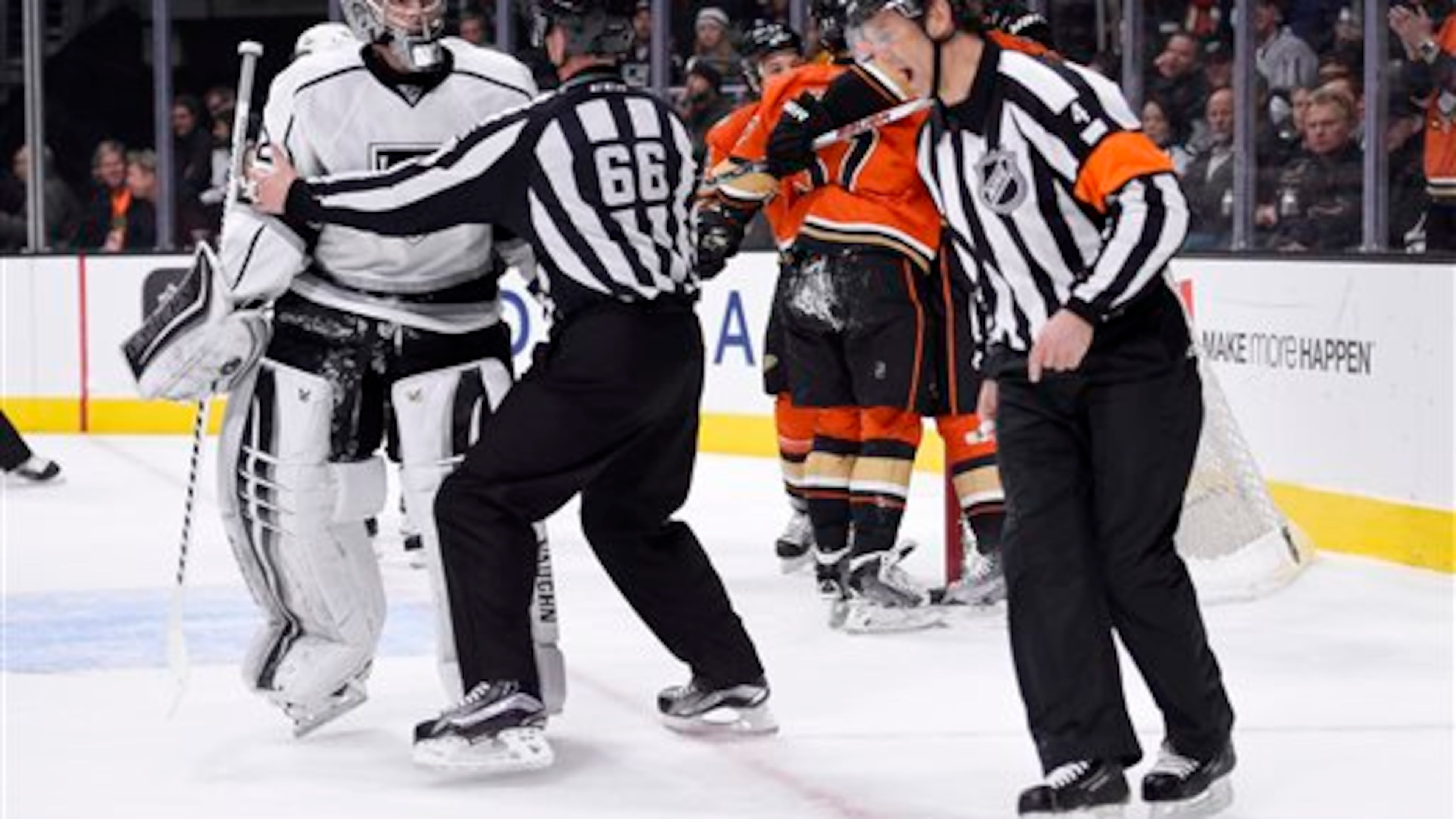 FILE - In this Feb. 4, 2016 file photo, Los Angeles Kings goalie Jonathan Quick, left, is held back away from referee Wes McCauley, right, by linesman Darren Gibbs after Anaheim Ducks left wing David Perron scored on Quick during the first period of an NHL hockey game, in Los Angeles. (AP Photo/Mark J. Terrill, File)