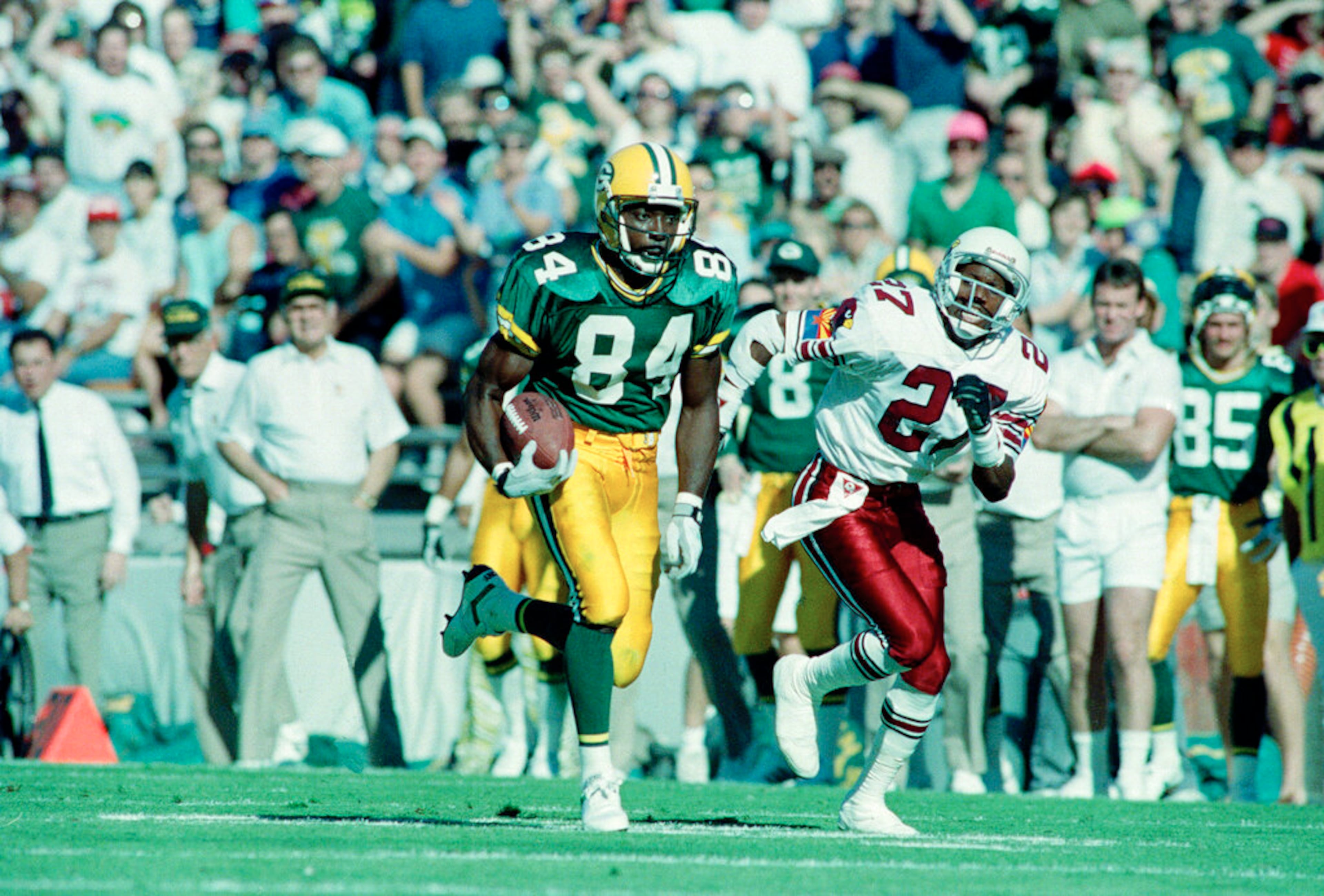Green Bay Packers wide receiver Sterling Sharpe (84), chased by Phoenix Cardinals Jay Taylor, heads towards the goal line to score the first touchdown in their game in Tempe, Nov. 18, 1990. (AP Photo/Jeff Kida)