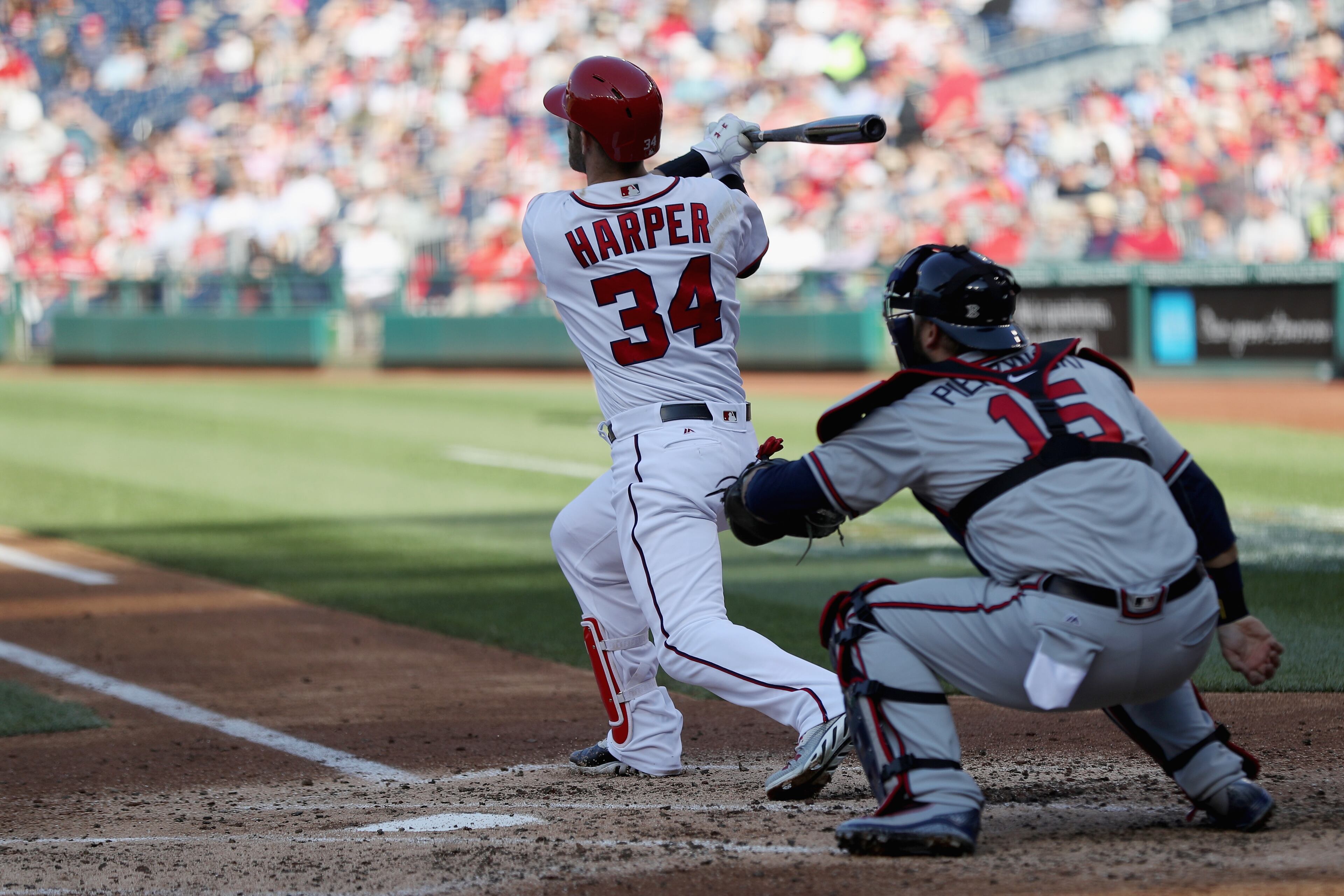 Catcher A.J. Pierzynski #15 of the Atlanta Braves looks on as Bryce Harper #34 of the Washington Nationals follows his third inning grand slam at Nationals Park on April 14, 2016 in Washington, DC. (Photo by Rob Carr/Getty Images)