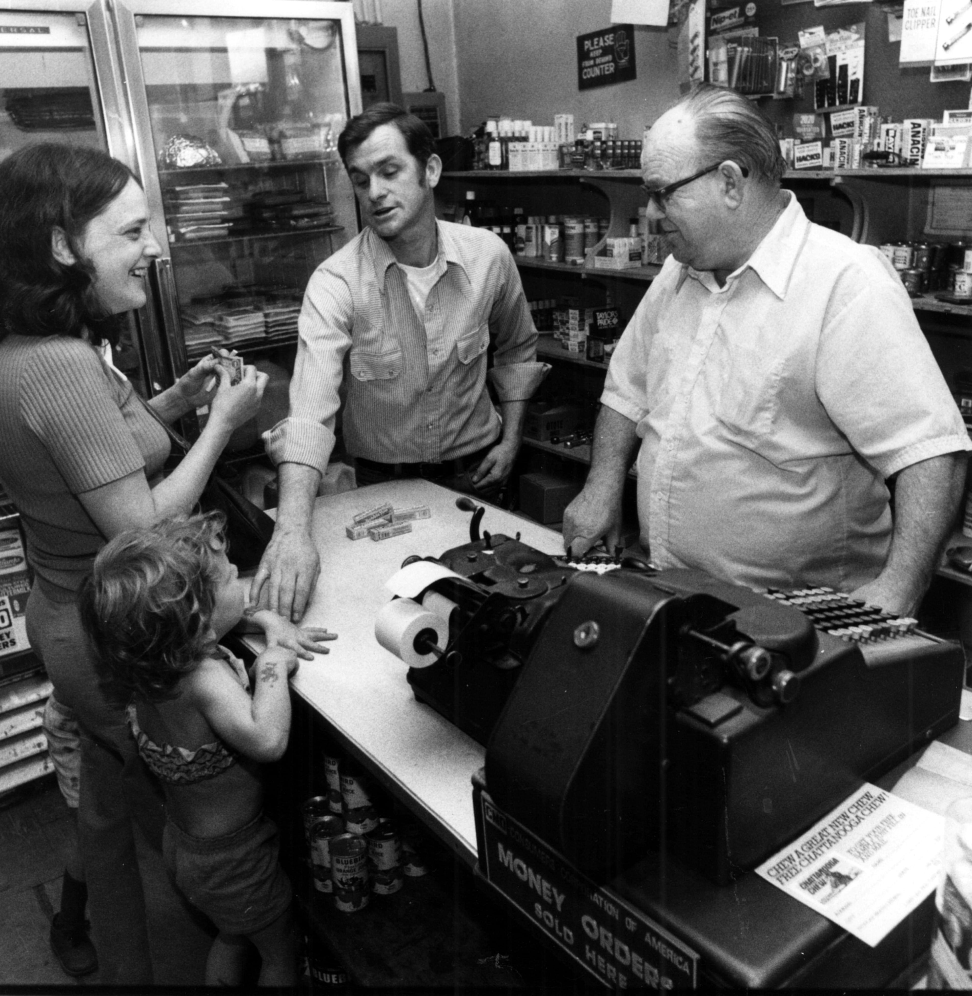June 19, 1979 - Atlanta, Ga.: William 'Mac' McCullum (right) and Raymond Henderson (left) wait on a customer at his small grocery store in Cabbagetown.