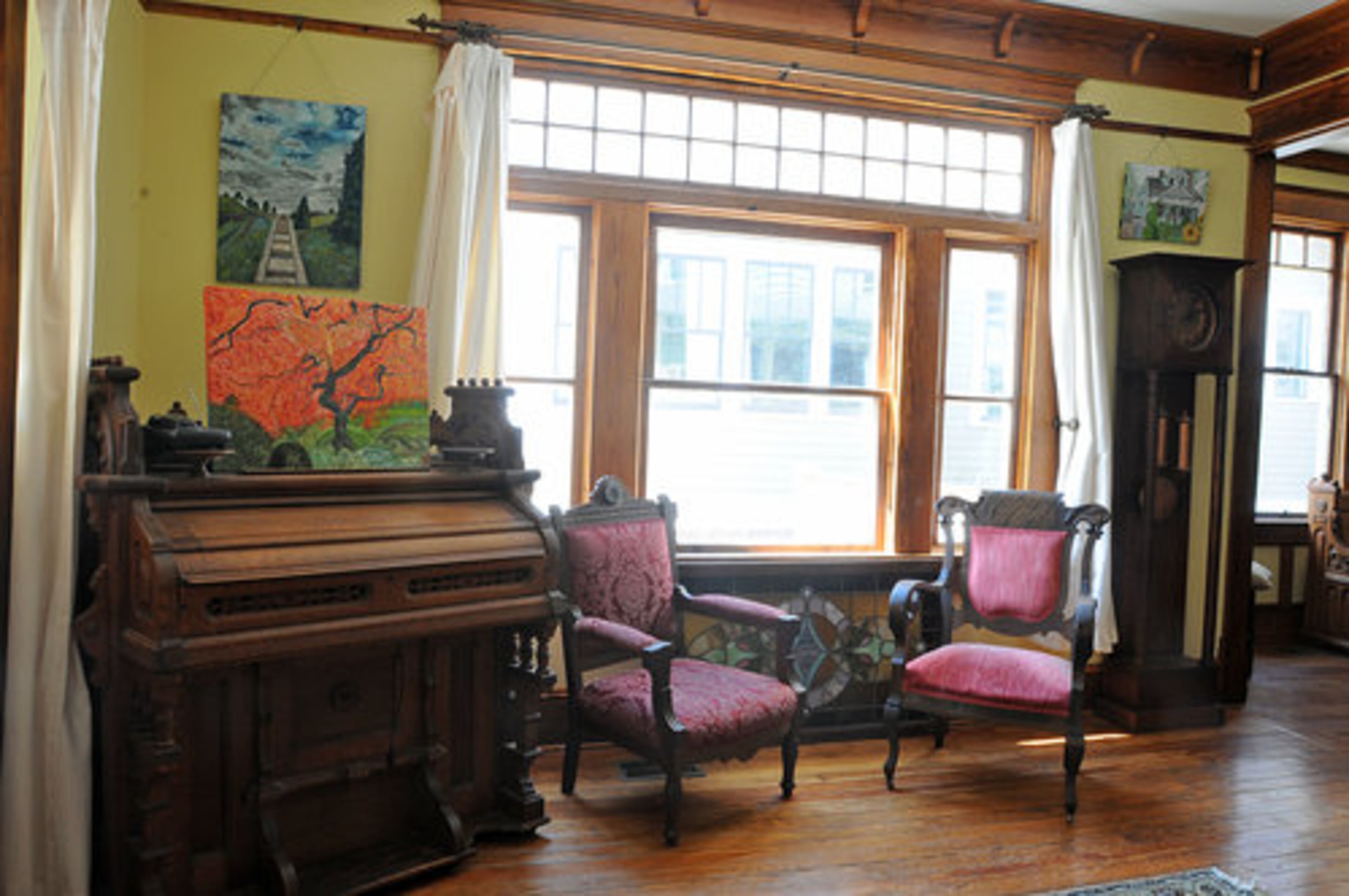 This is a Victorian organ that someone converted into a desk with a pull-out oak slab for writing. The lion's head chair (on the right) is from the 1840s and is walnut and part of a set that my parents gave me. The walnut Eastlake Victorian chair, on the left, is an antique store find.