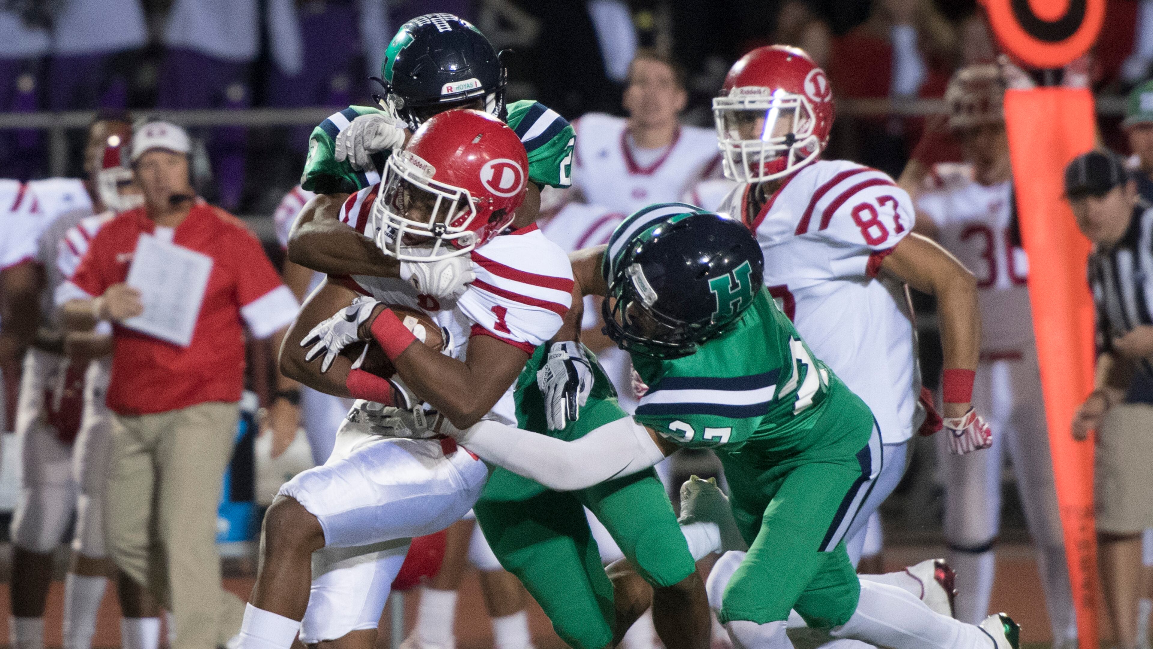Dalton QB Jahmyr Gibbs (1) runs for a TD as Harrison cornerback Mario Nunez and safety Tommy Pollack (27), tries to stop him during a high school football game on Thursday, Oct. 19, 2017, in Kennesaw, Ga. (Special to the Atlanta Journal-Constitution, John Amis )