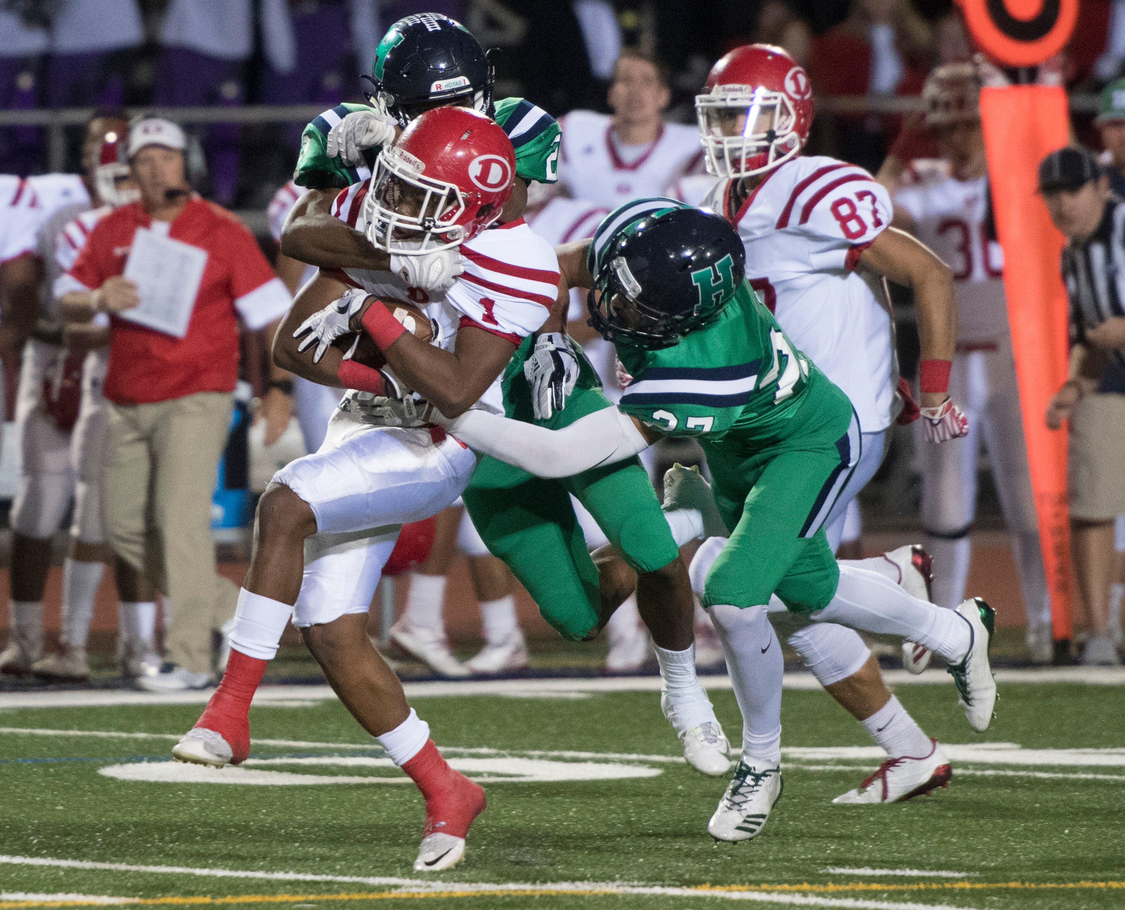 Dalton QB Jahmyr Gibbs (1) runs for a TD as Harrison cornerback Mario Nunez and safety Tommy Pollack (27), tries to stop him during a high school football game on Thursday, Oct. 19, 2017, in Kennesaw, Ga. (Special to the Atlanta Journal-Constitution, John Amis )