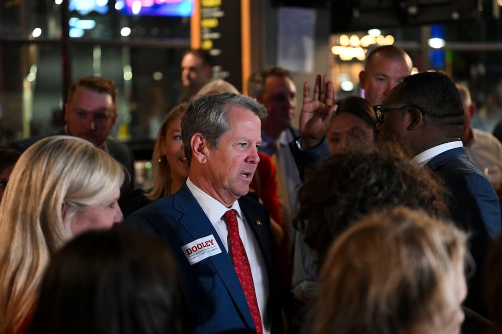Gov. Brian Kemp (center) greets supporters of Republican U.S. Senate candidate Derek Dooley at his election night party last month. (Daniel Varnado for the AJC)