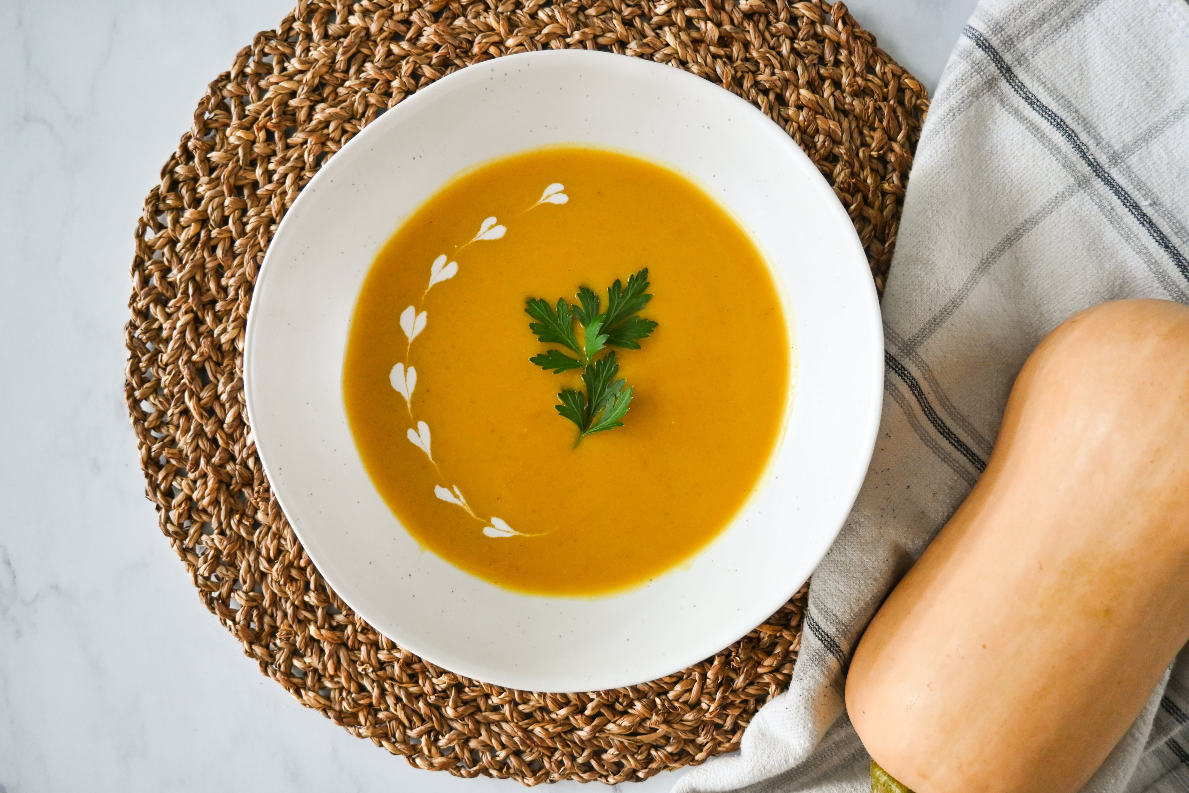 Coconut milk gives the same creaminess as heavy cream, and it makes this butternut squash soup lactose-free. (Candy Hom for the AJC)