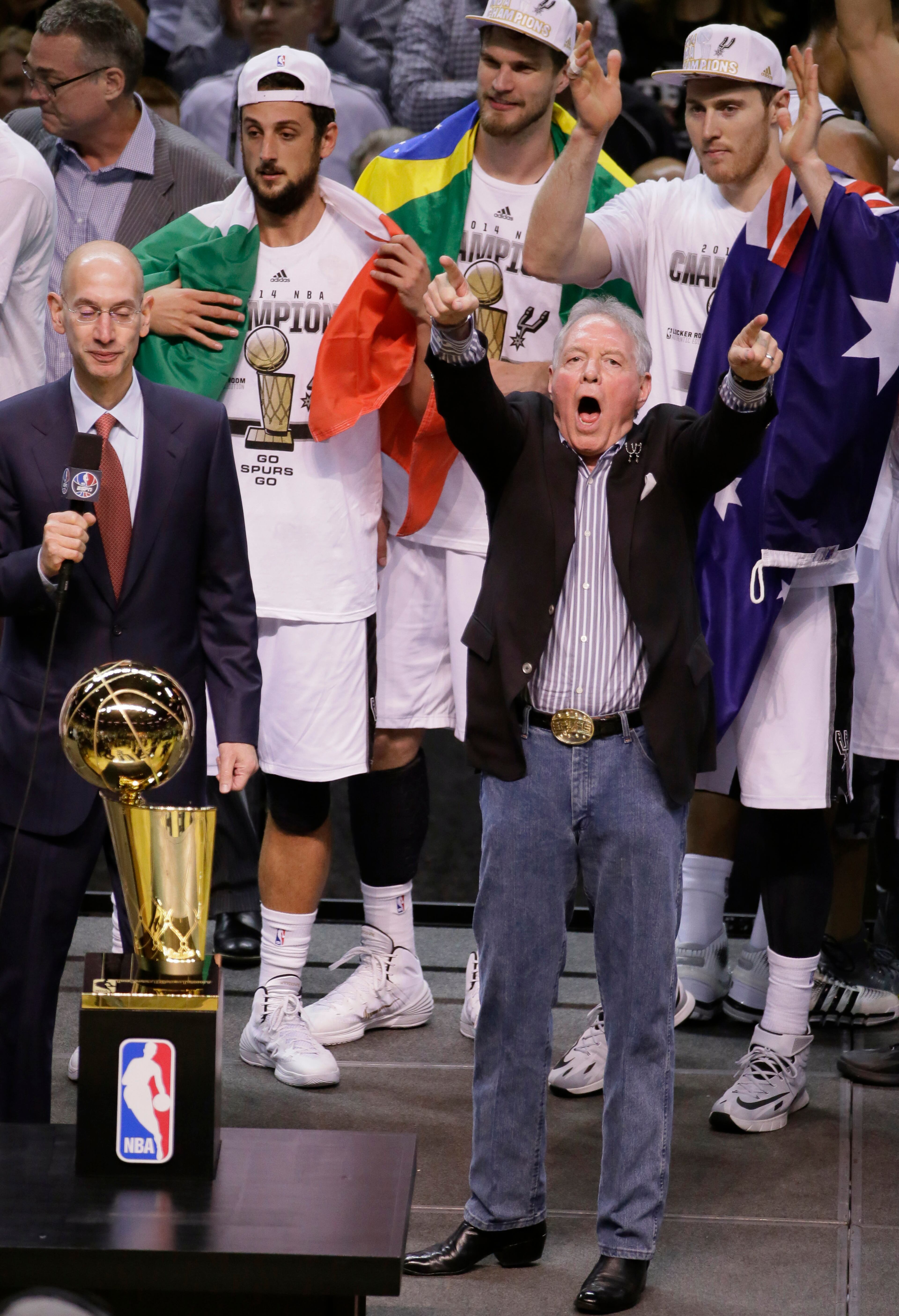 San Antonio Spurs owner Peter Holt celebrates with the team before receiving the Larry O'Brien NBA Championship Trophy after Game 5 of the NBA basketball finals against the Miami Heat on Sunday, June 15, 2014, in San Antonio. The Spurs won the NBA championship 104-87. (AP Photo/Tony Gutierrez)