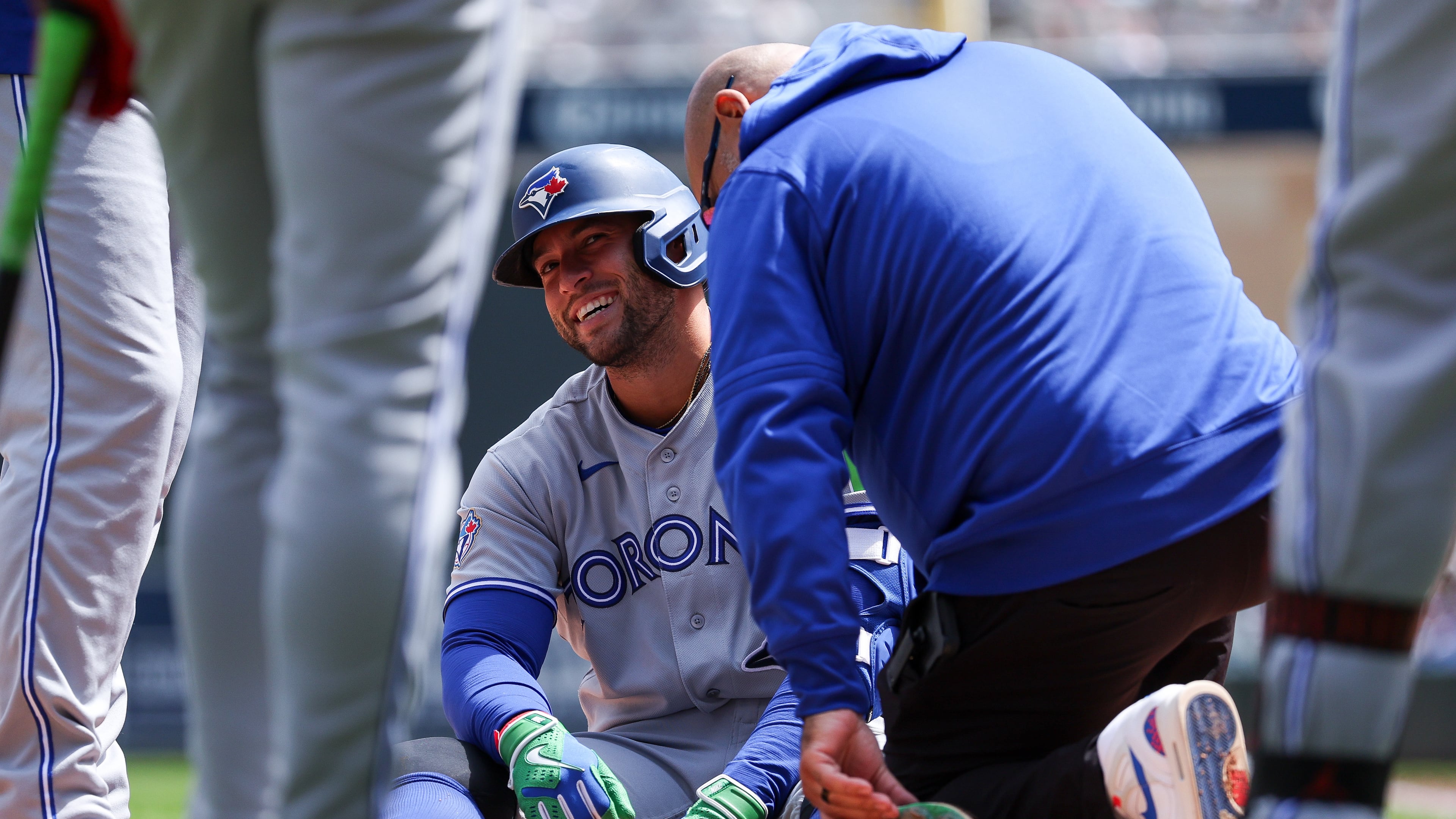 Toronto Blue Jays designated hitter George Springer is tended to after getting hit by a pitch during the third inning of a baseball game against the Minnesota Twins, Saturday, May 2, 2026, in Minneapolis. (AP Photo/Matt Krohn)