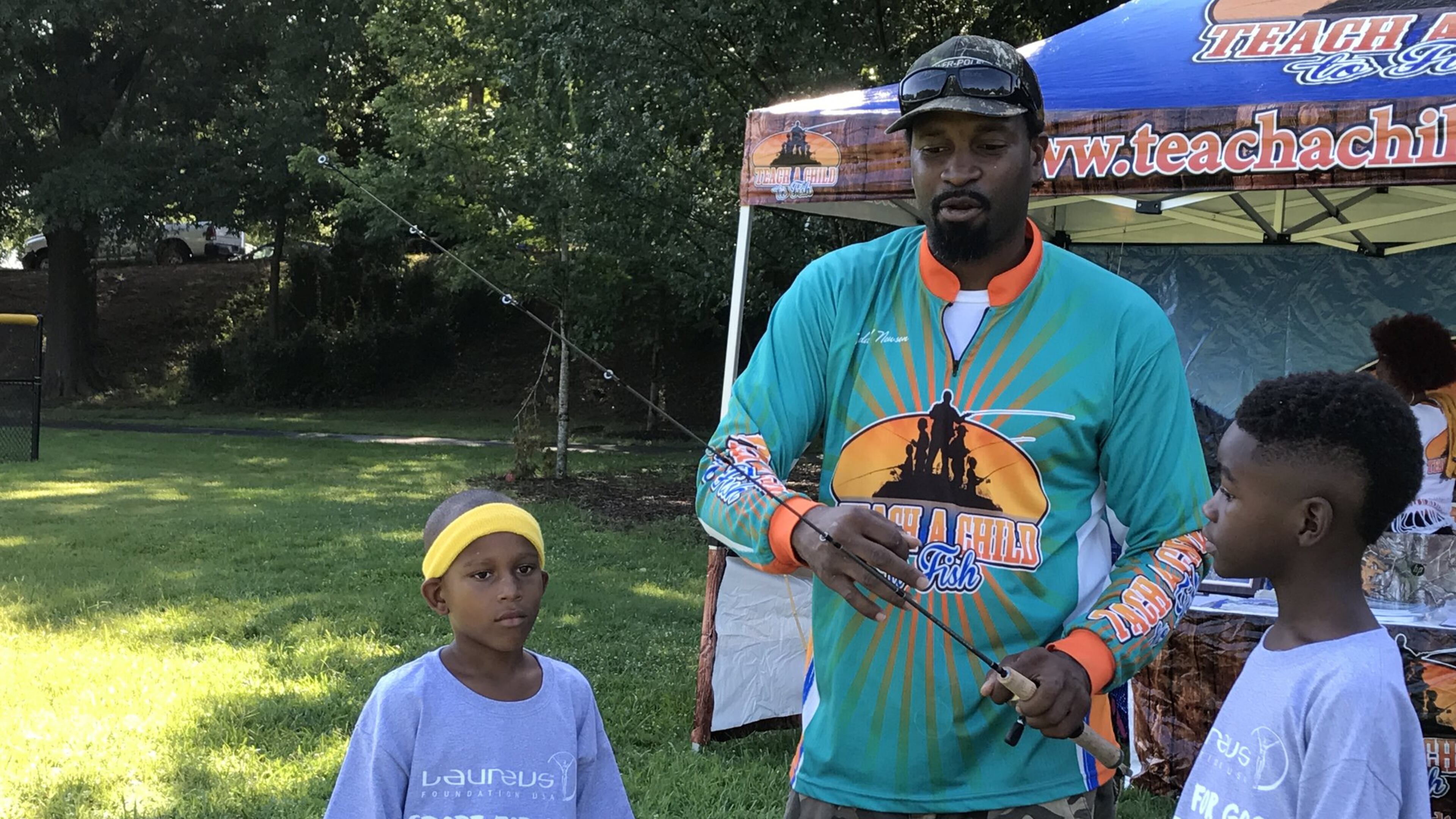 Former NFL player Kendall Newson runs a nonprofit called Teach a Child to Fish. He teaches youth to fish, something he has done since he was five years old. Here he is with participants Rico Hill and Richard Crowder.