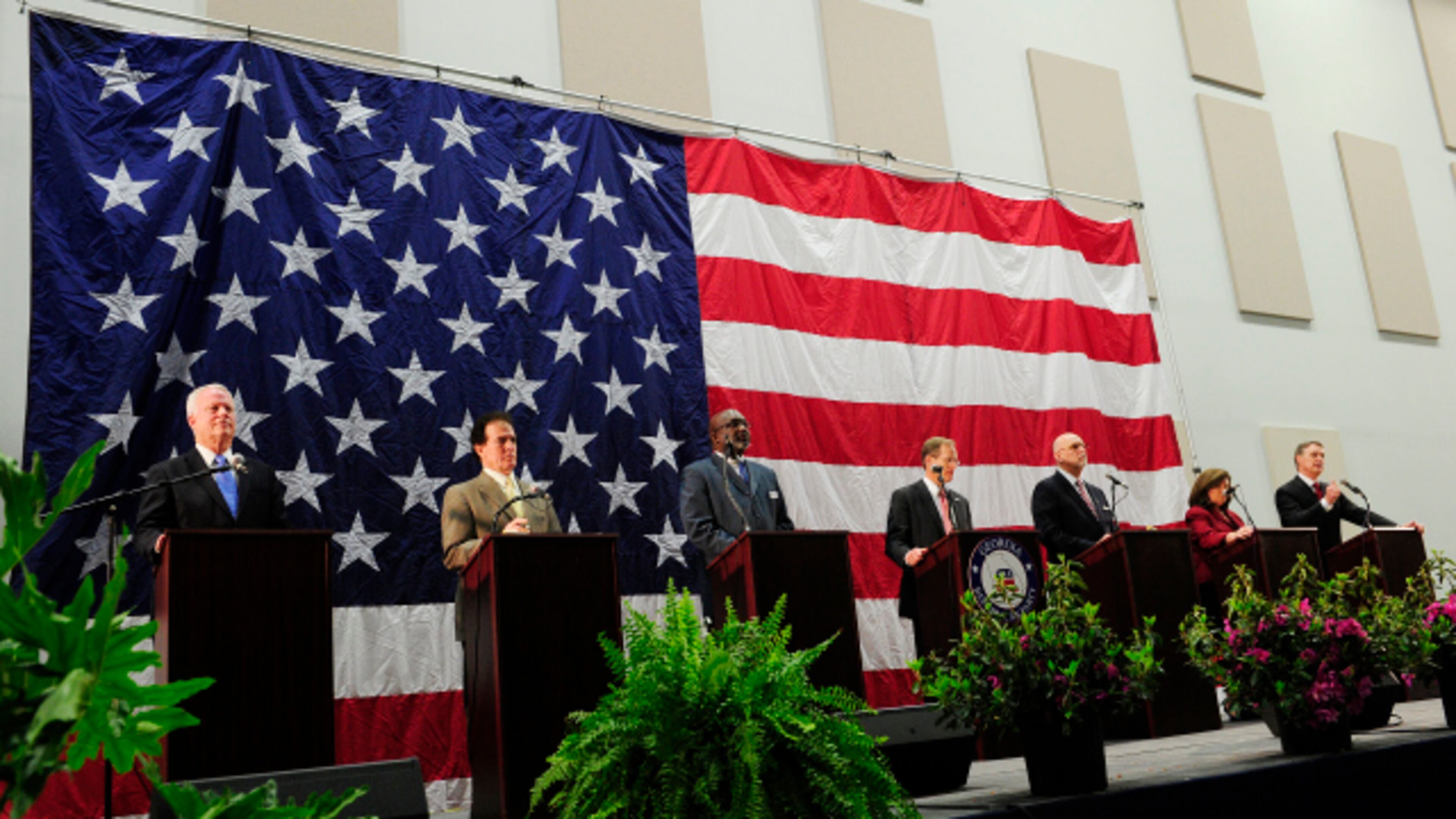 From left, U.S. Reps. Paul Broun and Phil Gingrey, Derrick Grayson, Rep. Jack Kingston, Arthur Gardner, Karen Handel, and David Perdue stand at their podiums near the end of a U.S. Senate debate of GOP candidates.