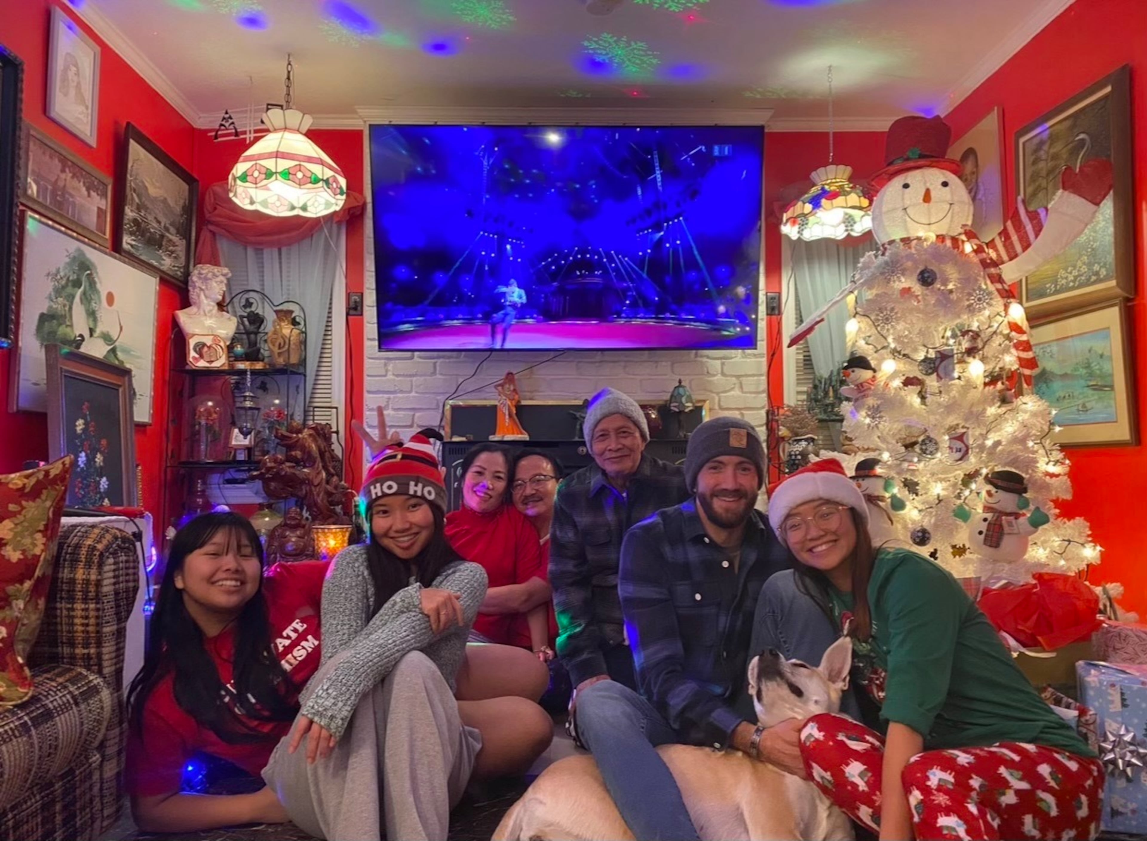 The Dang family is shown at a recent Christmas. From left are sisters Maggie and Mitchel Dang, mother Truc Ngo, father Minh Dang, grandfather Be Dang, Michael Retzer, and oldest sister Mary Dang with her dog, Azula.