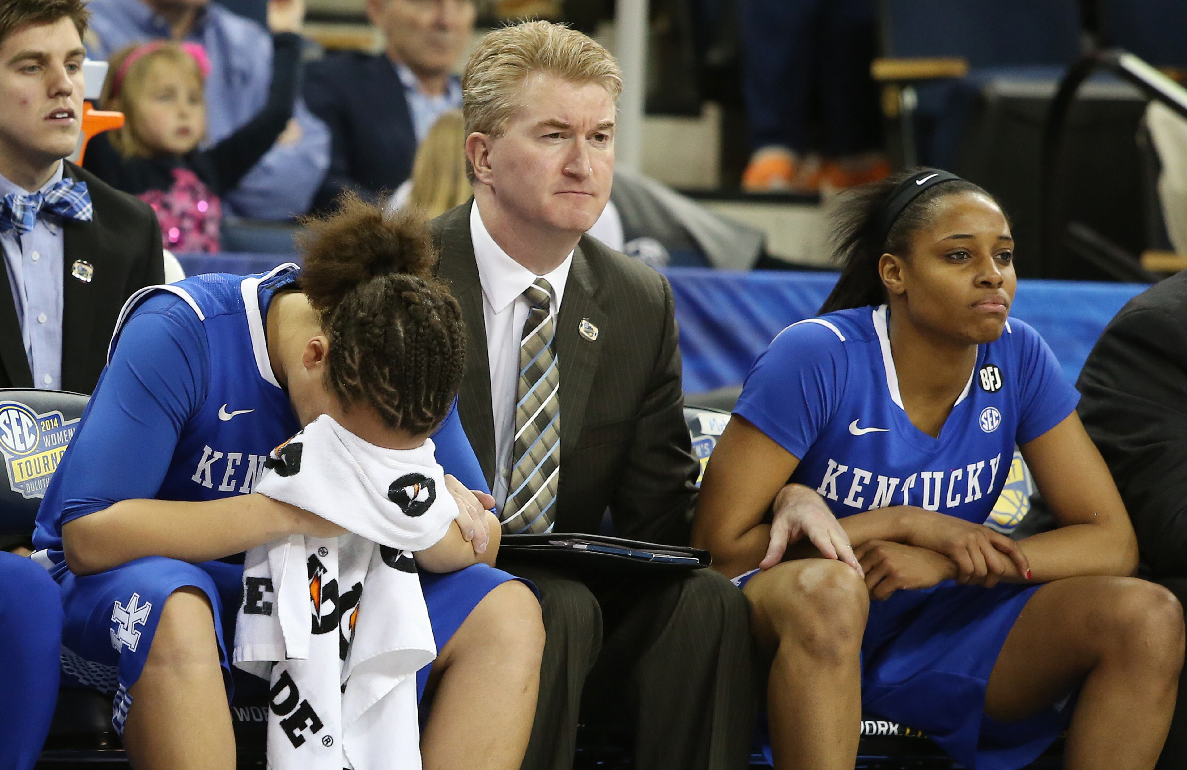 Kentucky guard Makayla Epps, left, sits on the bench with assistant coach Jeff House and teammate Bria Goss, right, in the finals moments of the second half of an NCAA college basketball game against Tennessee in the finals of the Southeastern Conference women's basketball tournament Sunday, March 9, 2014, in Duluth. Tennessee won 71-70. (AP Photo/Jason Getz)