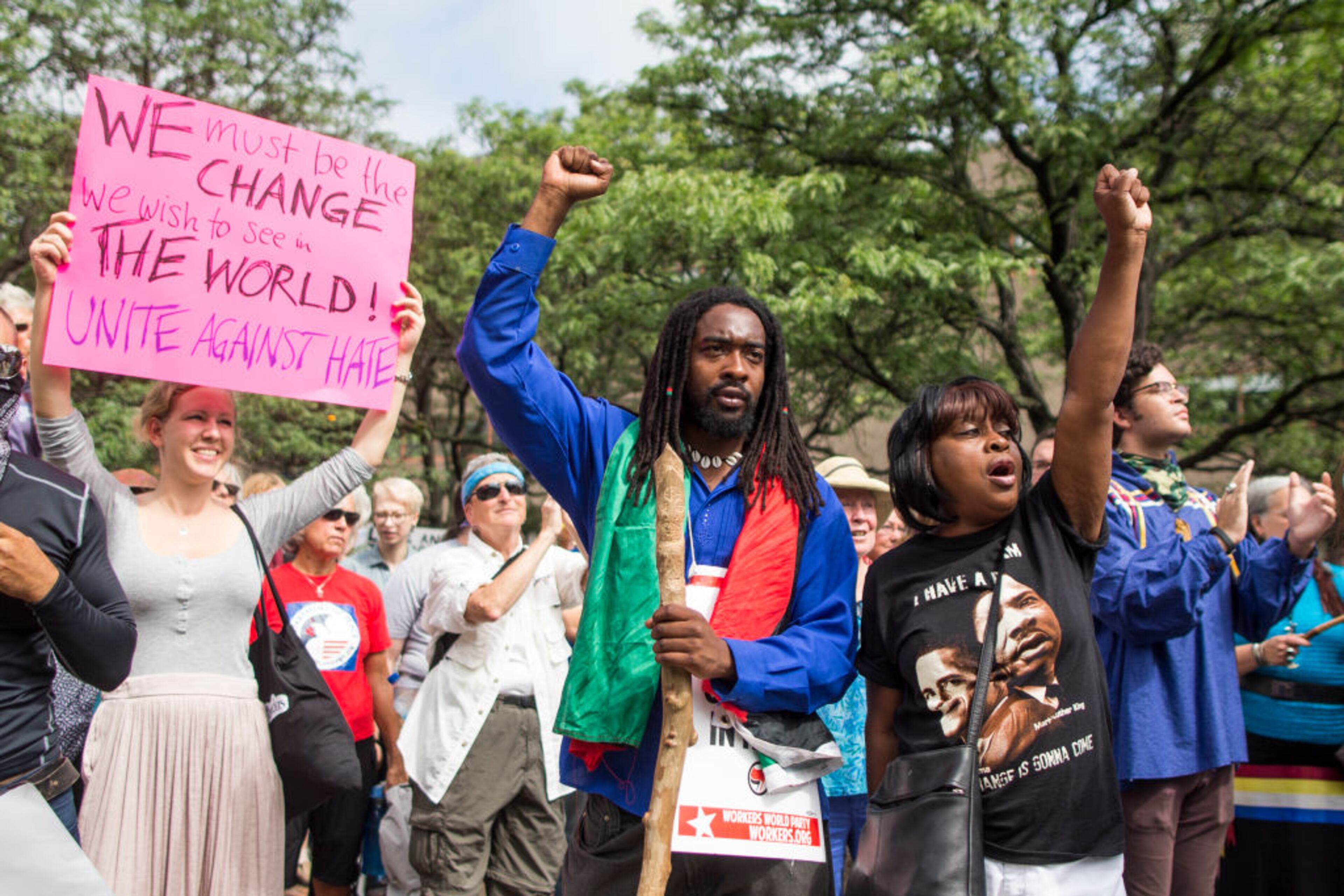 BOSTON, MA - AUGUST 19: Counter protesters raise their fists before marching to a planned 'Free Speech Rally' on Boston Common on August 19, 2017 in Boston, Massachusetts. Thousands of demonstrators and counter-protestors are expected at Boston Common where the Boston Free Speech Rally is being held. (Photo by Scott Eisen/Getty Images)